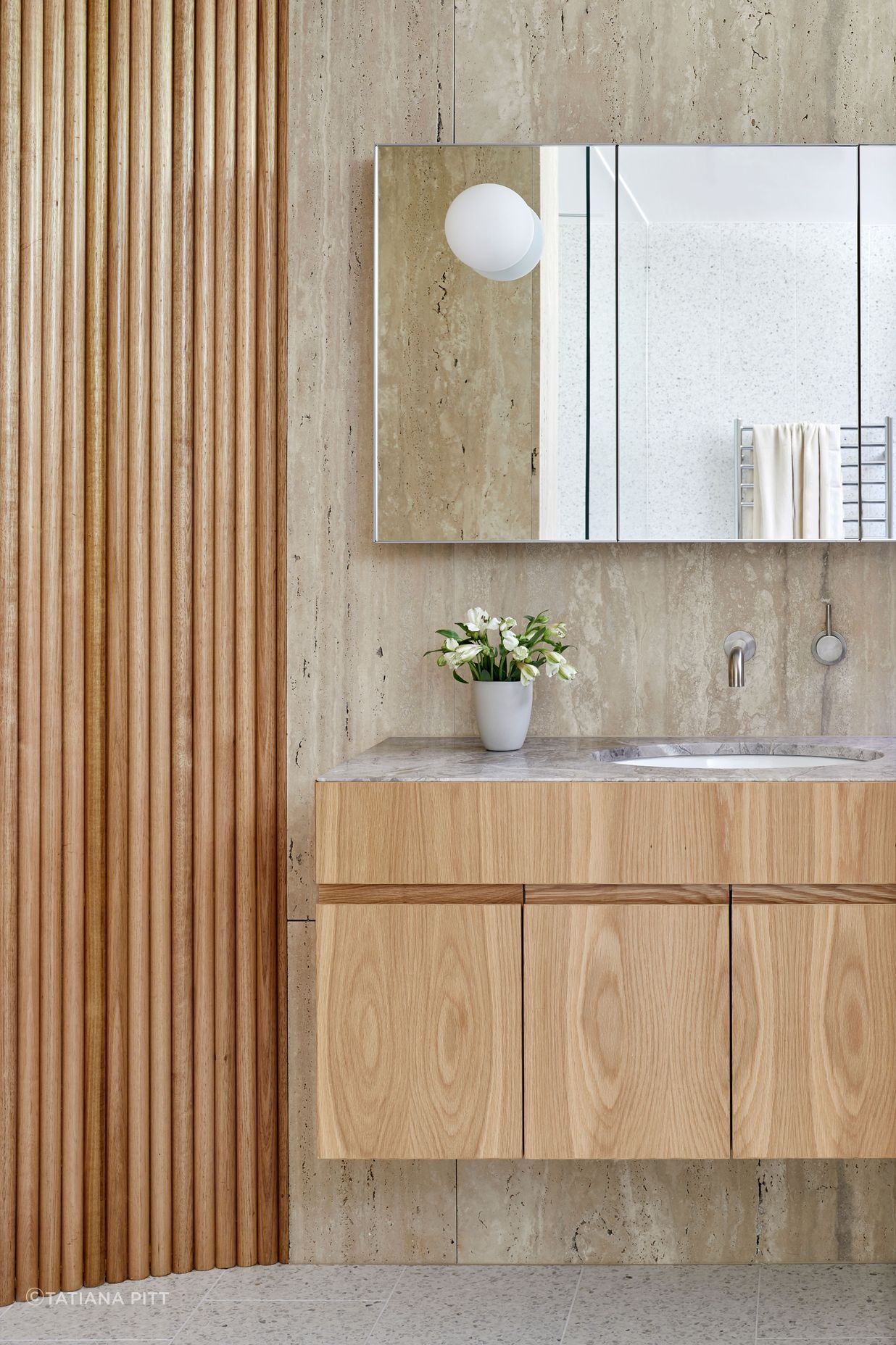 The bathrooms combine timber, terrazzo floor tiles, limestone and marble, bringing interest at every turn.