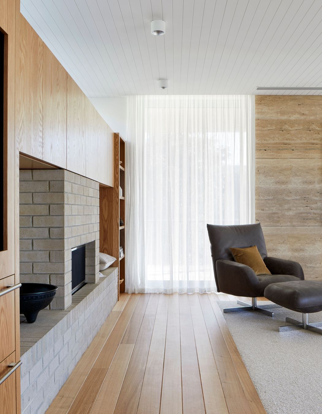 American oak flooring frames the inset wool carpets.