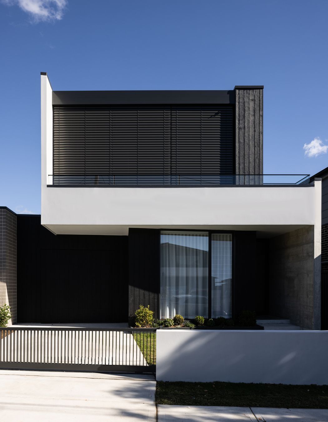 Motorised blinds provide privacy for the main bedroom.