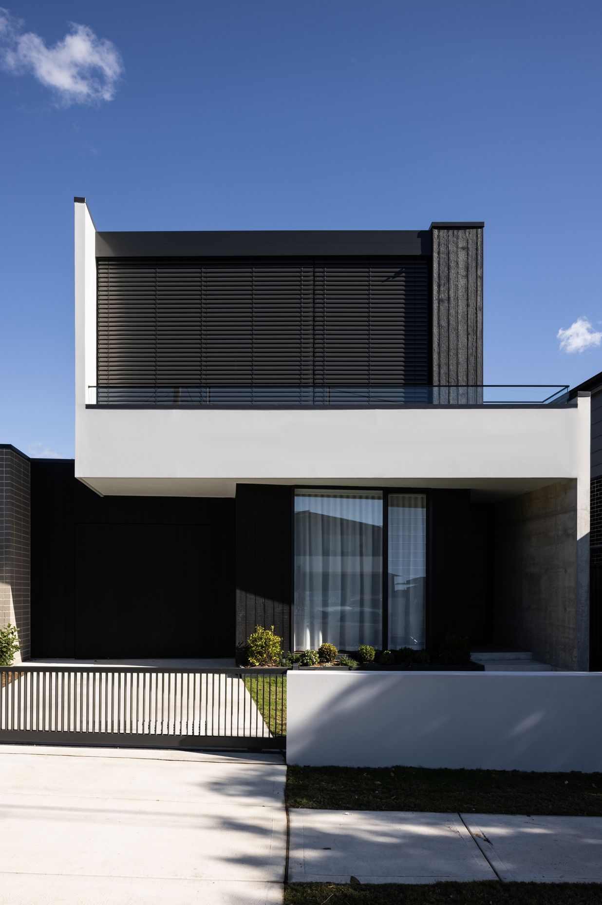 Motorised blinds provide privacy for the main bedroom.