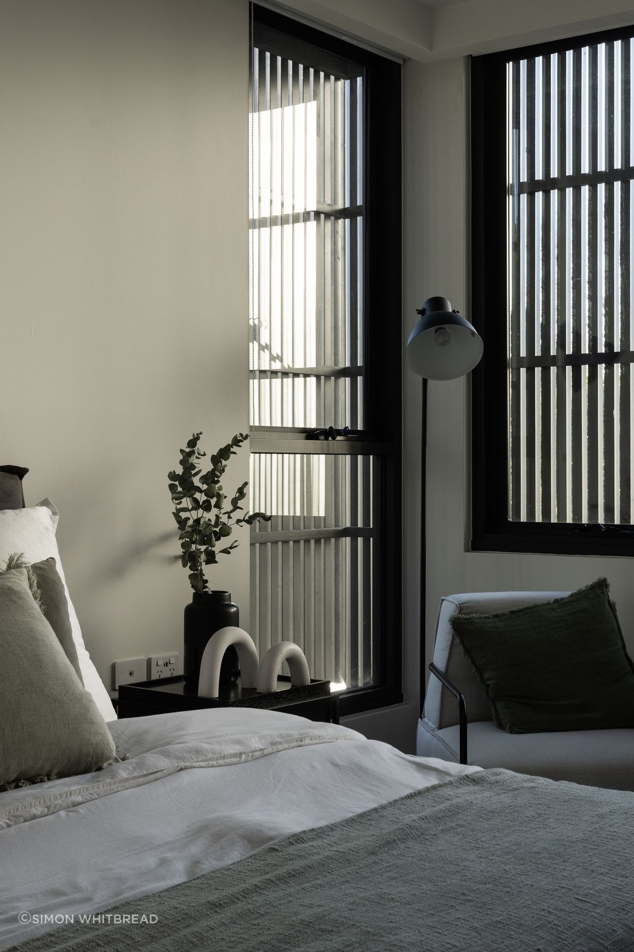 Inside, the blinds add interest to the main bedroom.