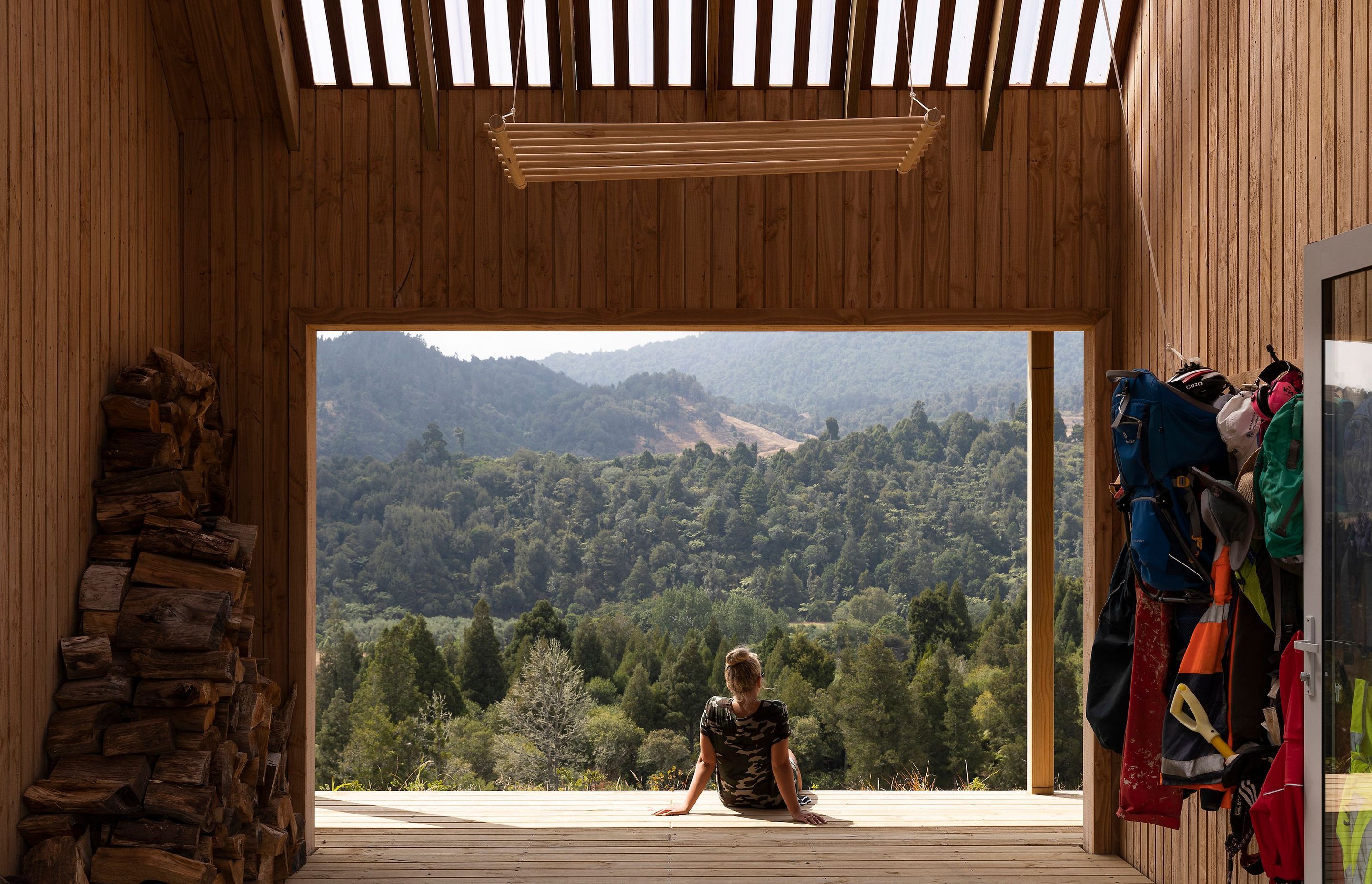 A semi-transparent roof draws soft, filtered light into the outdoor room. In cooler weather, barn doors enclose the space.