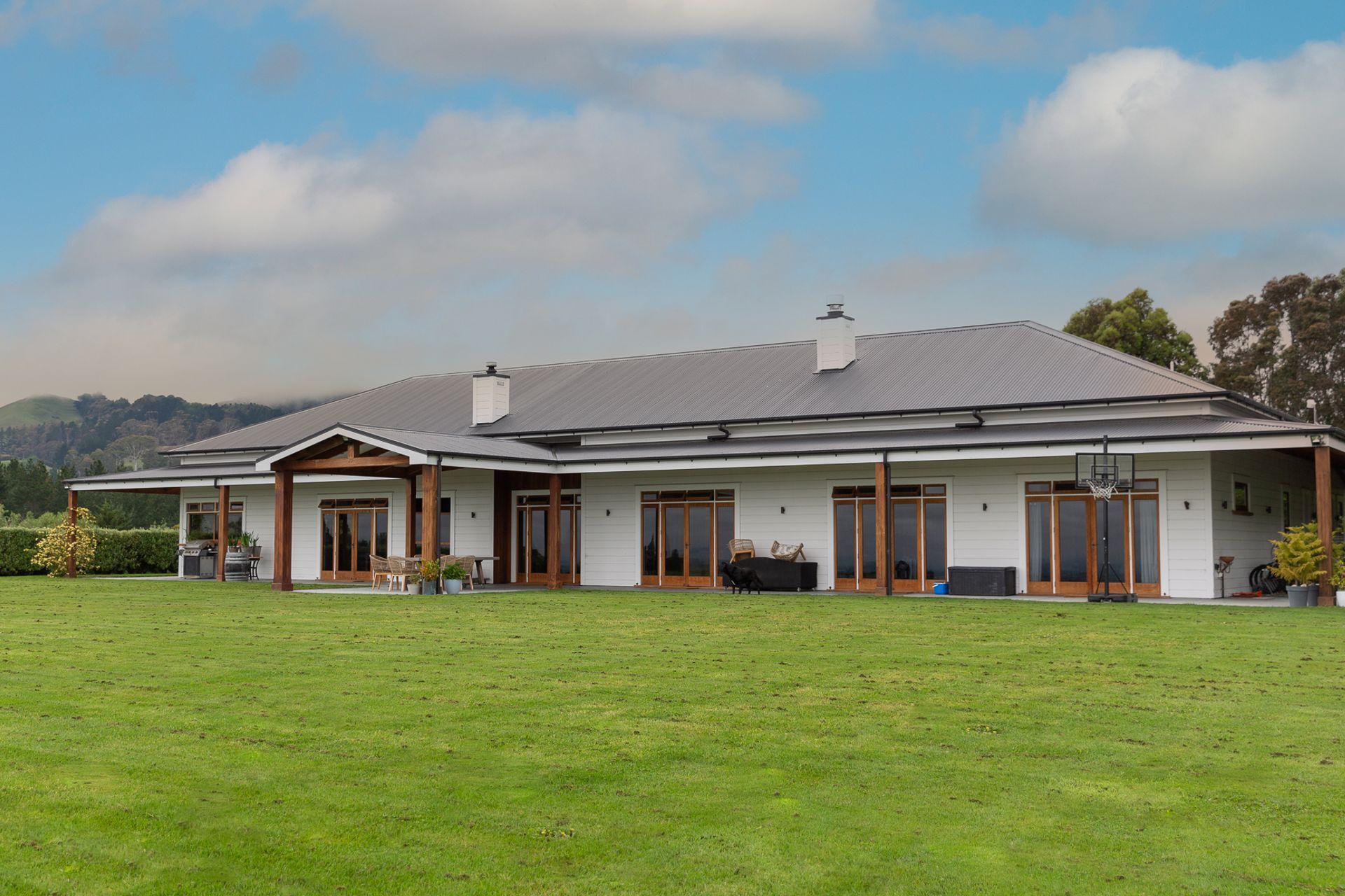 Bespoke cedar posts and framing transform this new build into homestead comfort.