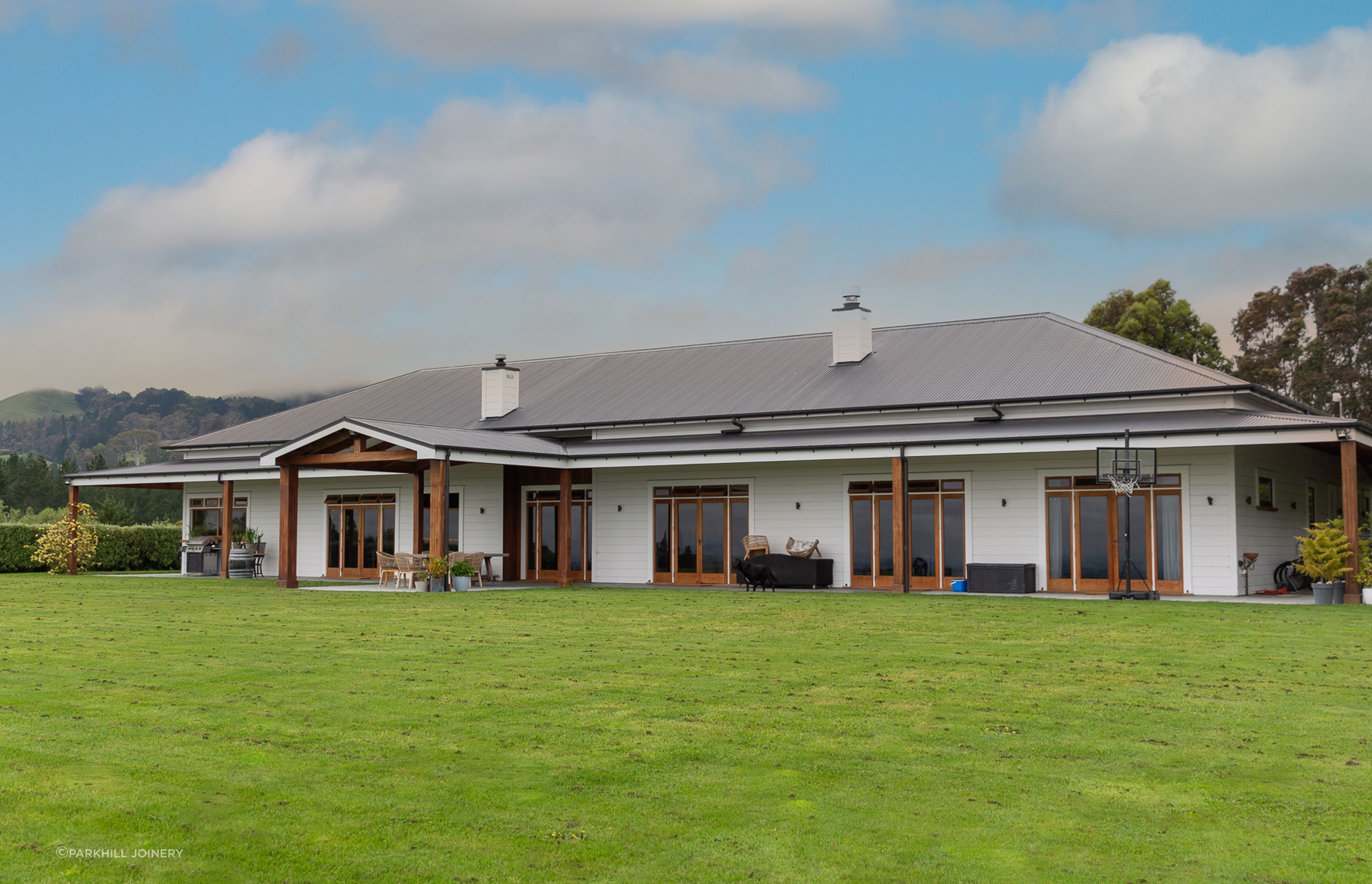 Bespoke cedar posts and framing transform this new build into homestead comfort.