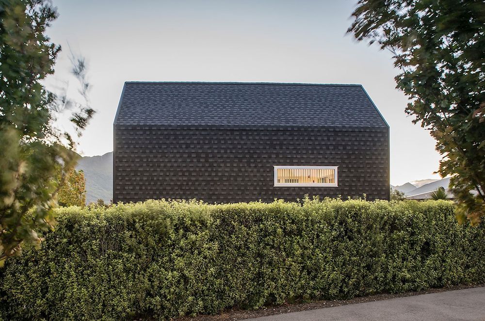 A bold kerbside view from across the hedge of the Kimimoko House