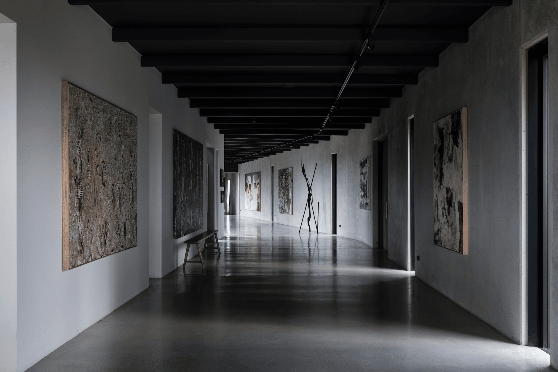 The trio of contemporary spaces tie into a polished concrete gallery housing the owners' tasteful art collection.