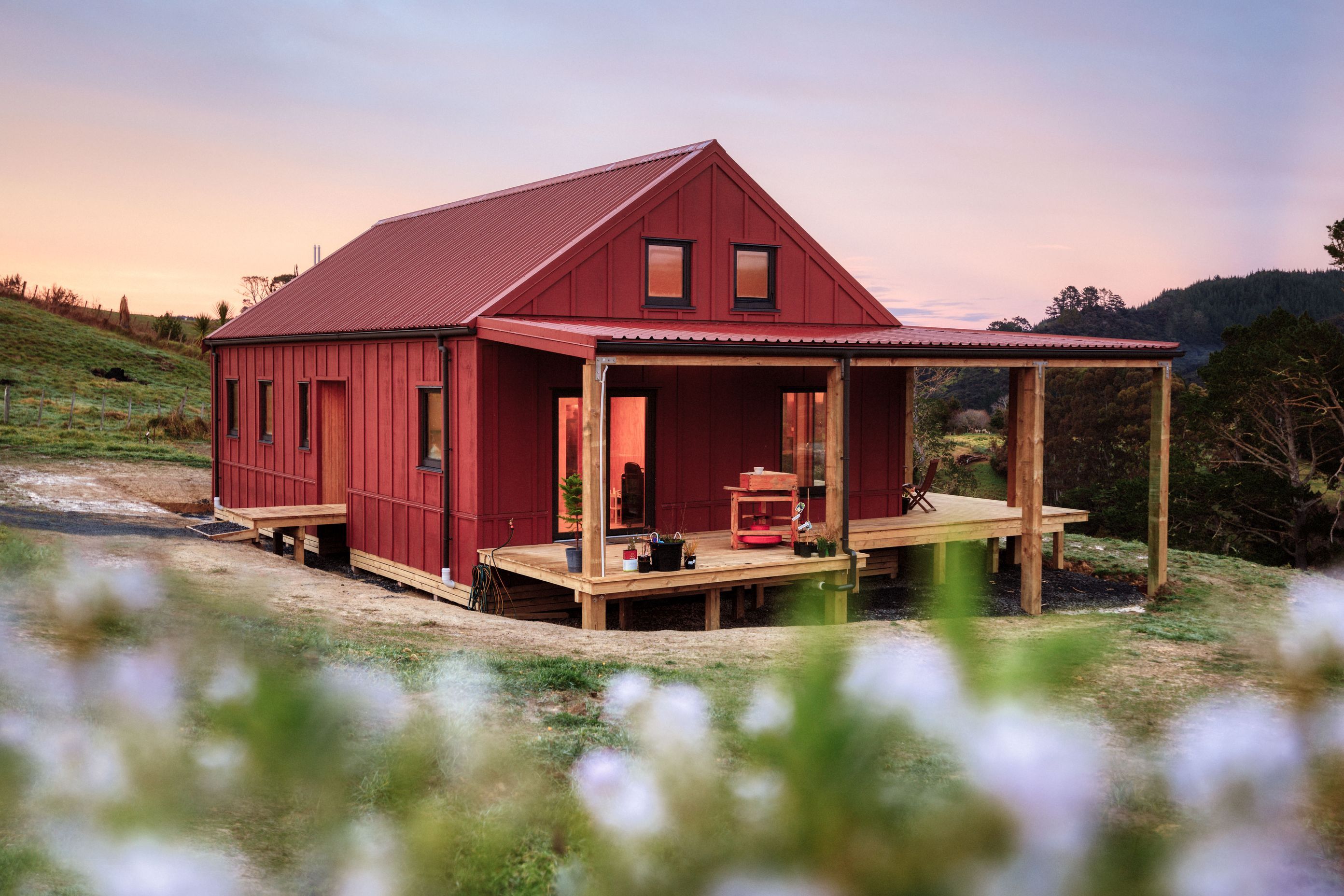 The house exterior is Resene Scoria. “It's beautiful. When it’s really sunny it’s a warm cherry red, but when it's a bit more overcast, it's got that sort of rusty brown look to it. It informed our material choices inside as well.”