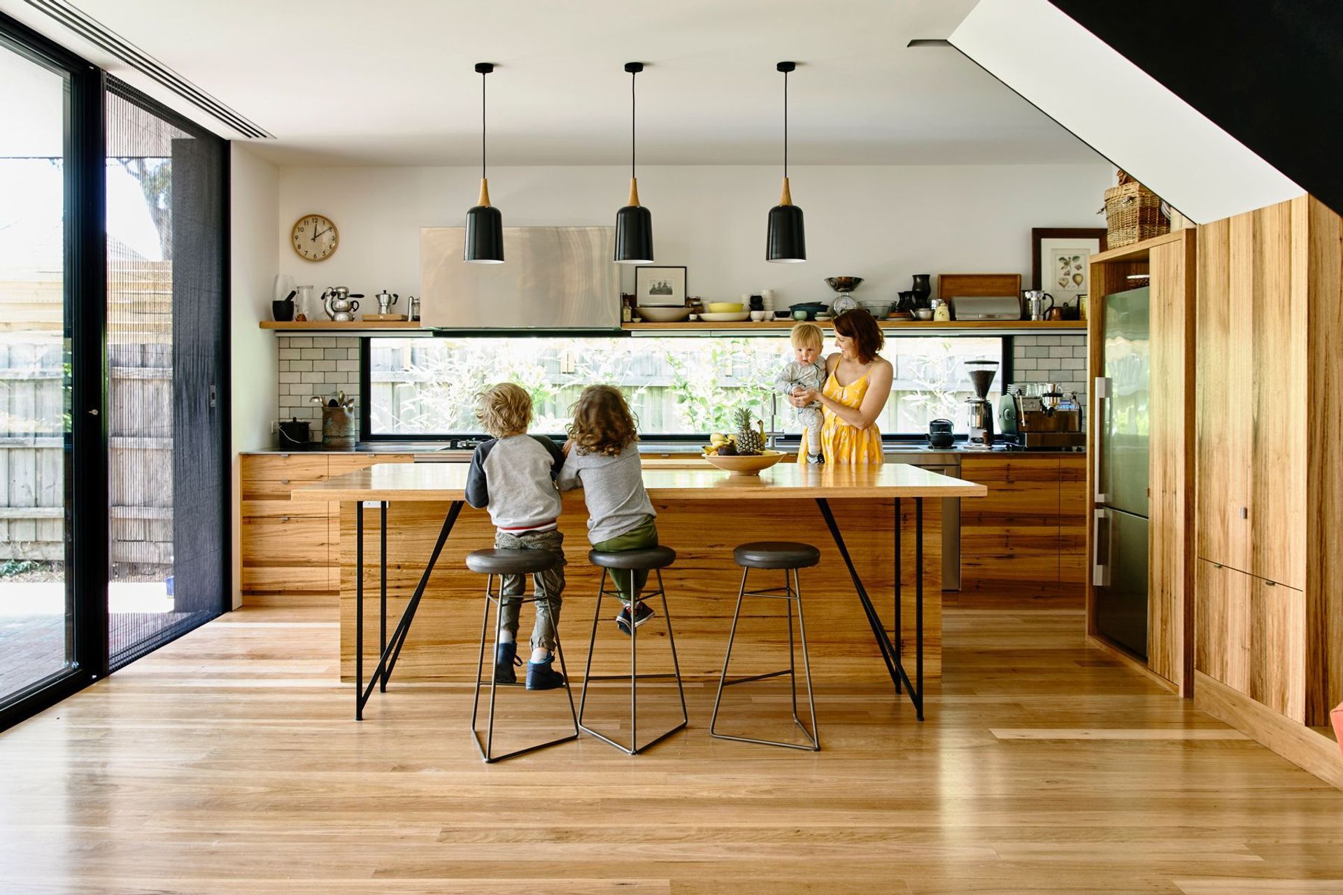 The timber kitchen draws the family together.