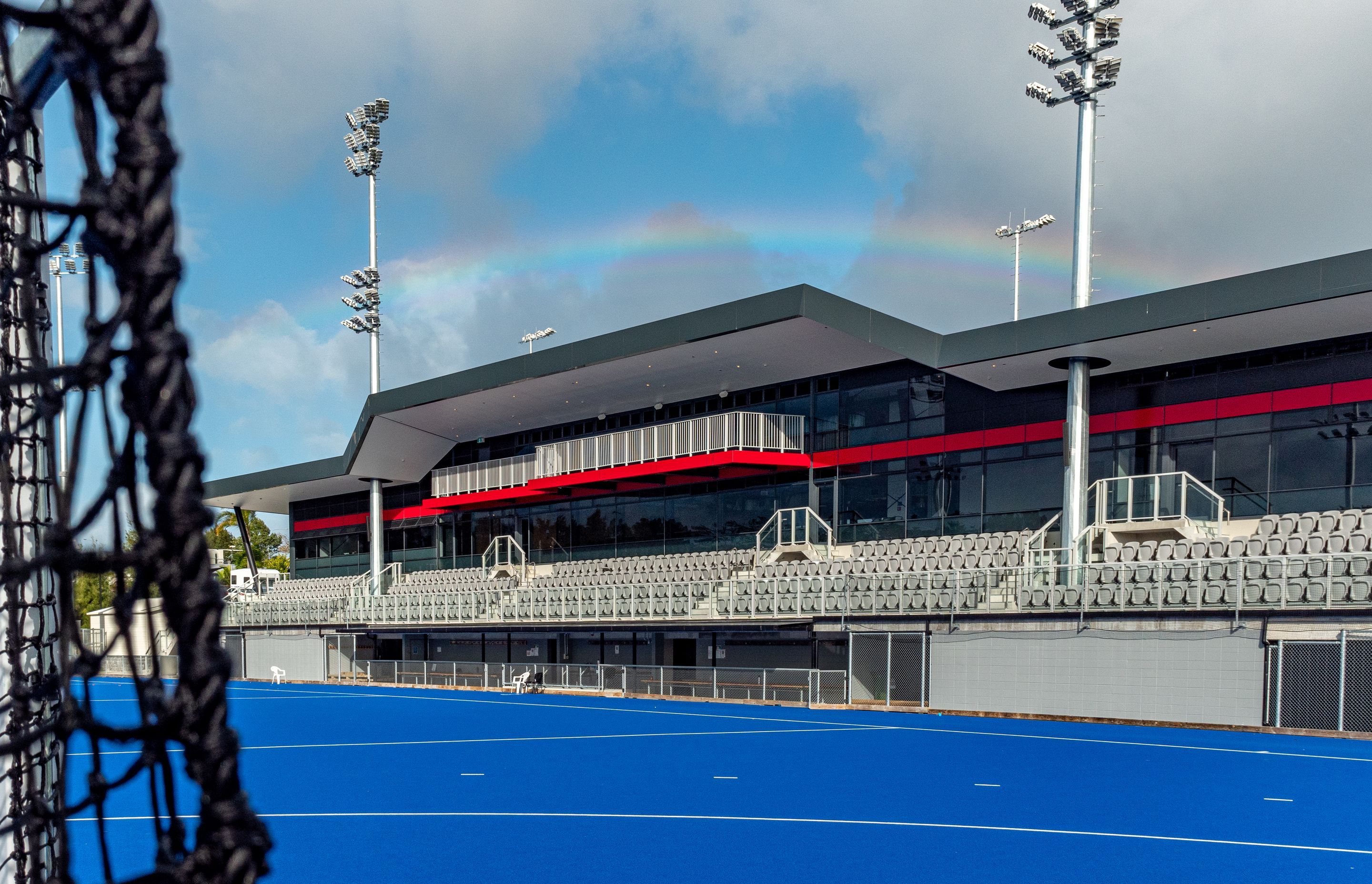 Panelab was contracted to supply, measure, fabricate and install the Solid Aluminium Alucolux System in Dark Grey Metallic and Ruby Red on the National Hockey Centre.