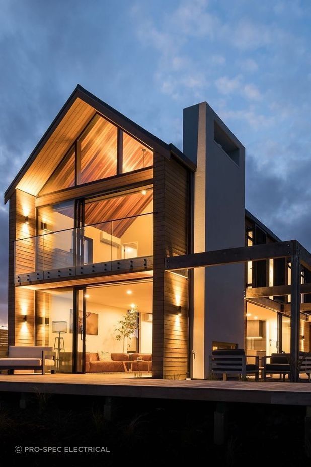 Pro-Spec Electrical enhanced this home's backyard exterior with meticulously chosen architectural lighting, embracing depth and dimension through the use of Up/Down lighting.