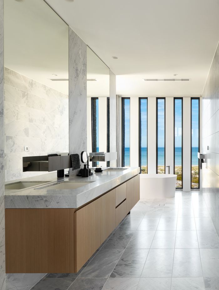 Ensuite with free-standing bath and ocean views | Tennyson Residence by Enzo Caroscio Architects