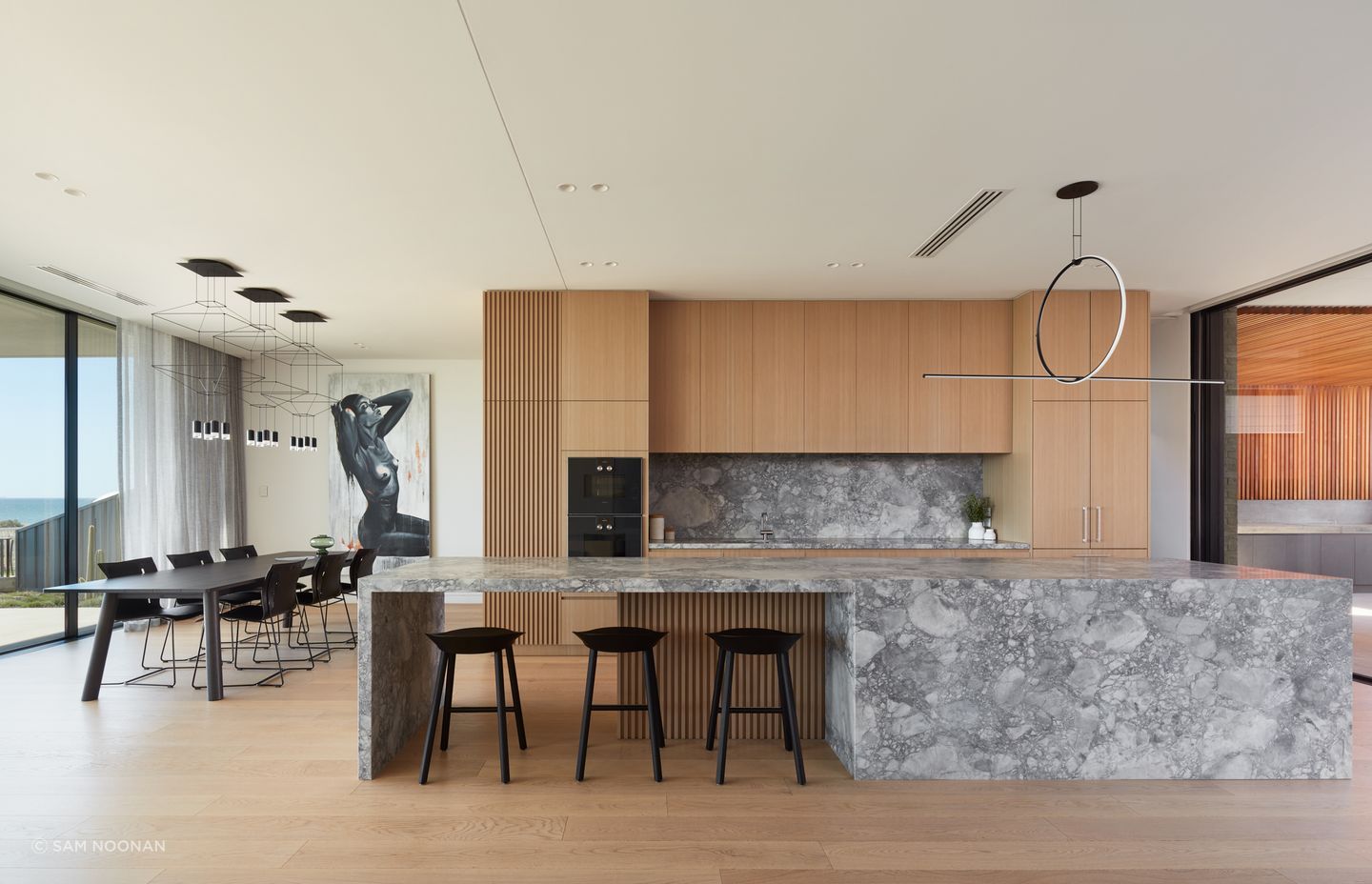 The four-and-a-half metre-long kitchen island takes centre stage in the living area | Tennyson Residence by Enzo Caroscio Architects