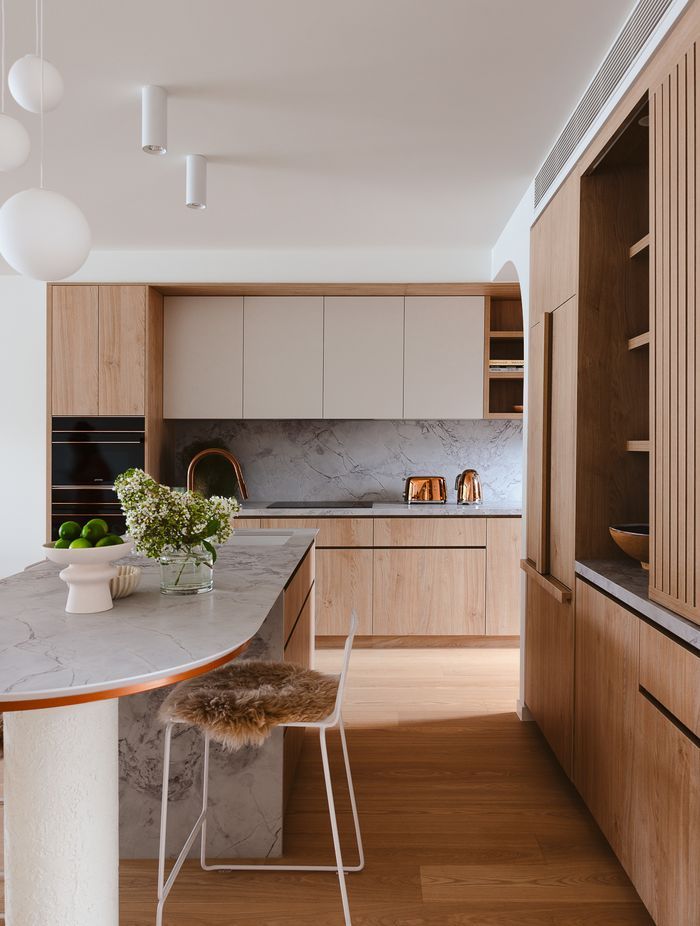 Timber cabinetry adds warmth beside Quantum Zero in Super White Palazzo.