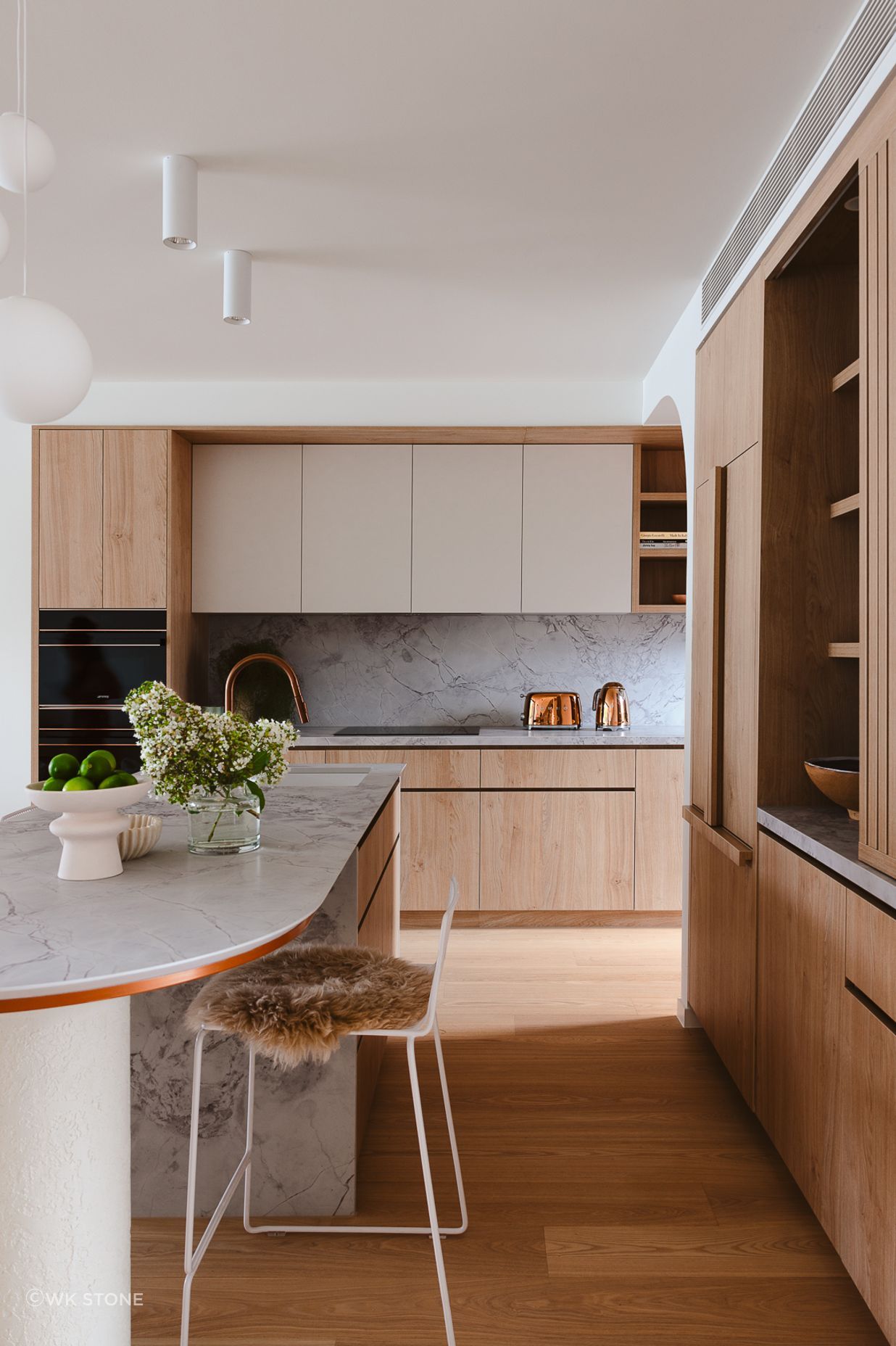 Timber cabinetry adds warmth beside Quantum Zero in Super White Palazzo.