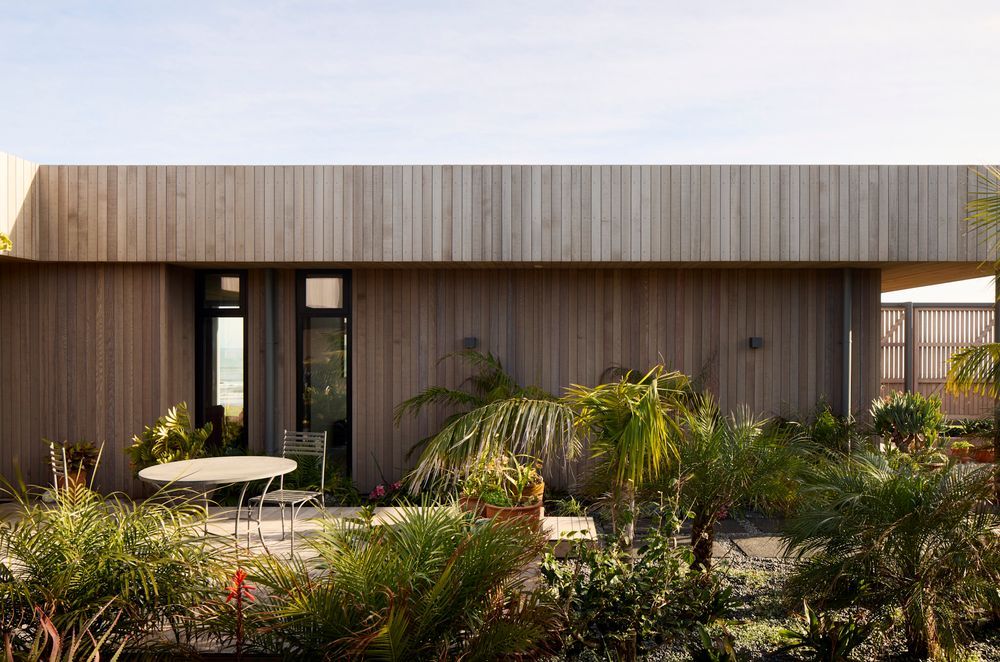 The entranceway winds through a lush garden
