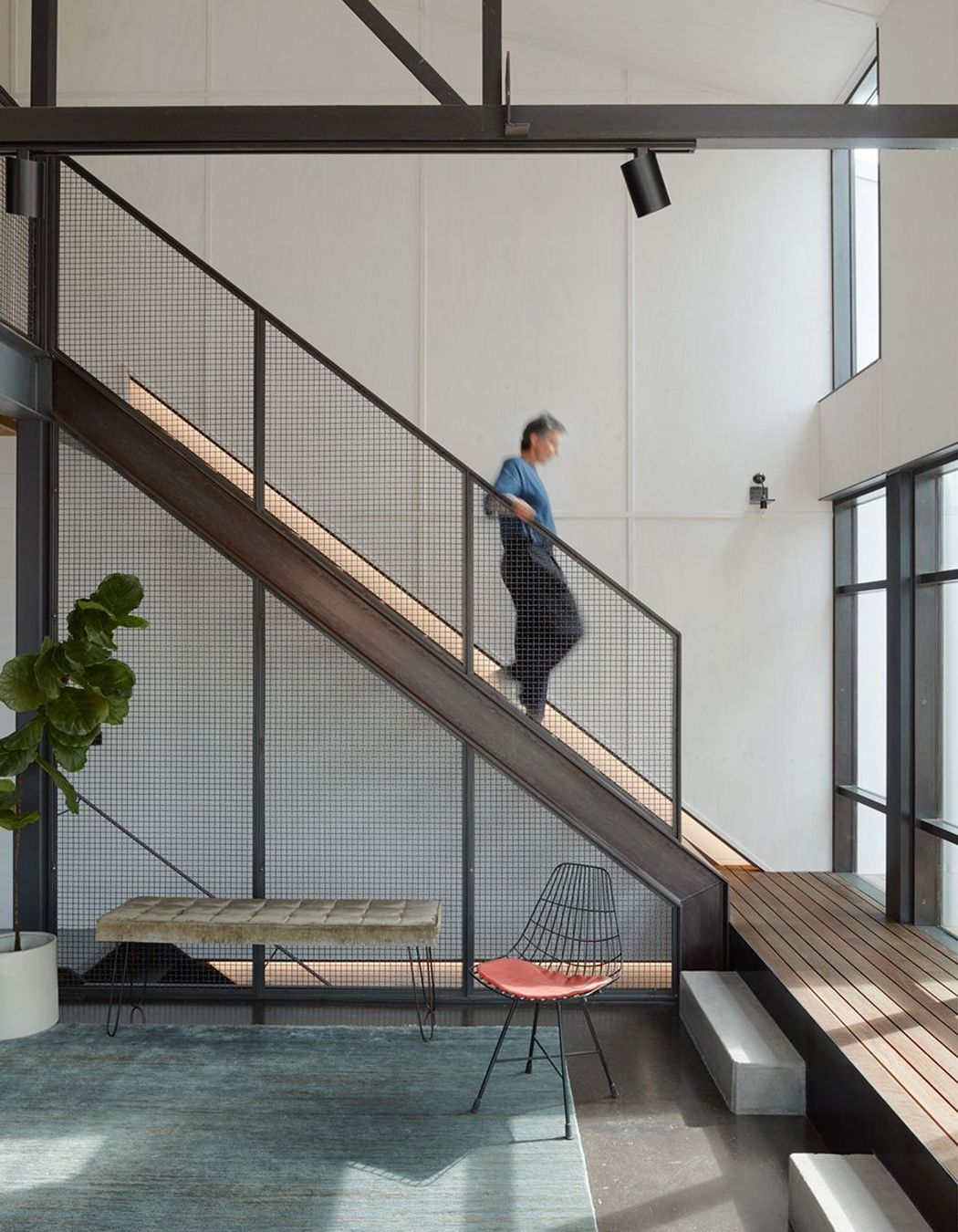 The heart of the home lies through a tucked-away staircase, bathed in natural light – a combined living, cooking and dining area.