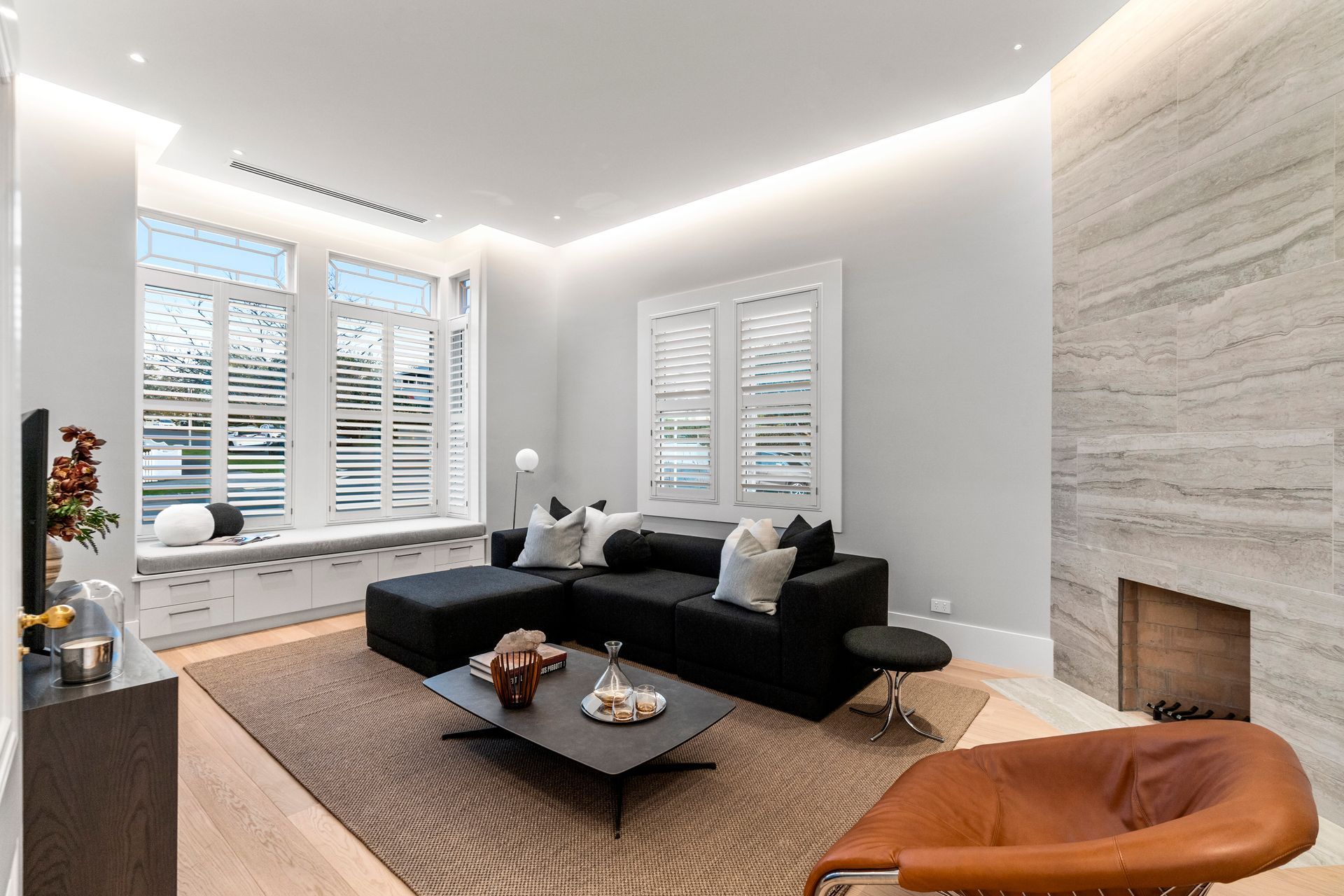 The living room features a floor-to-ceiling sandstone tile fireplace.