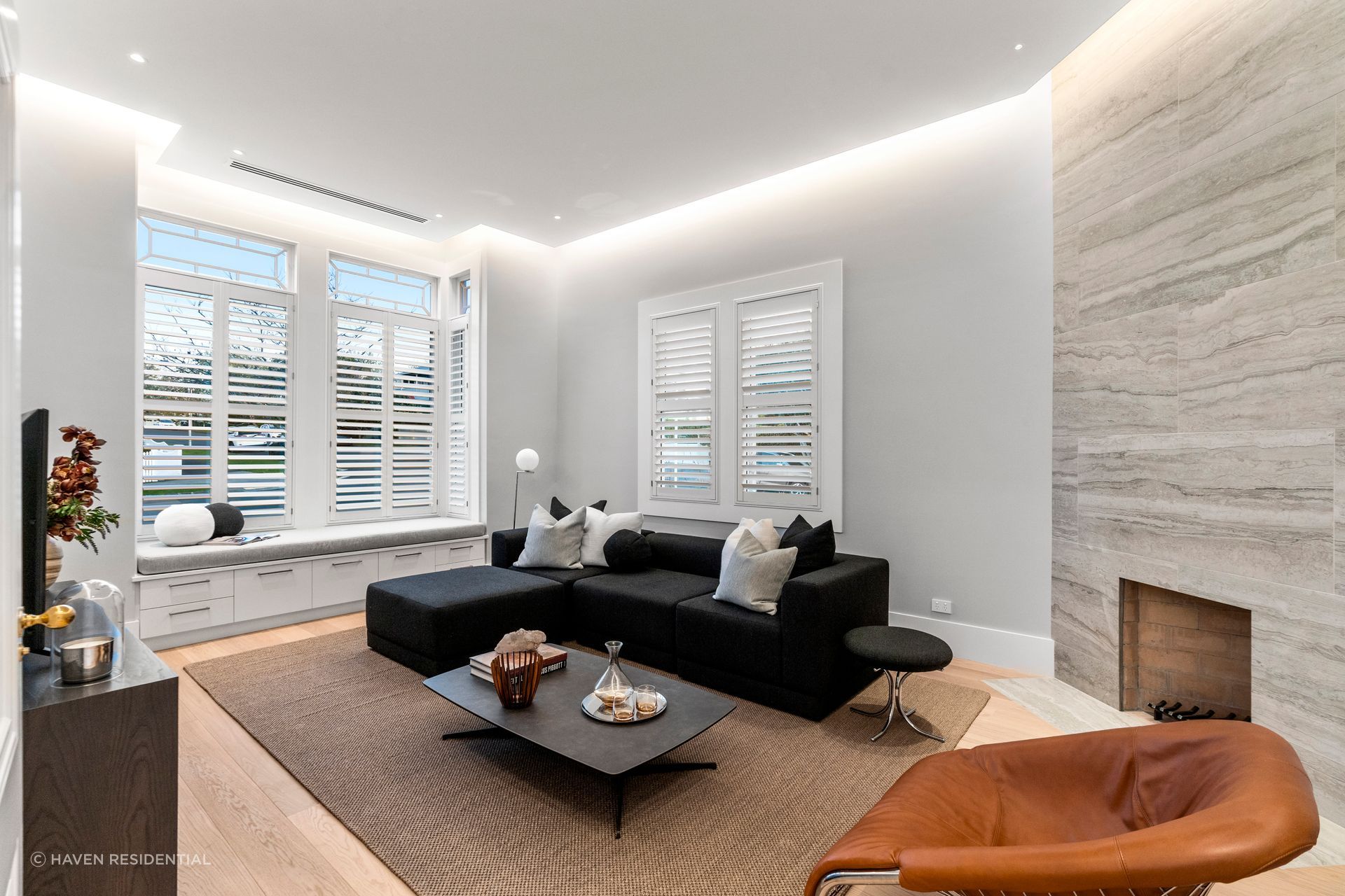 The living room features a floor-to-ceiling sandstone tile fireplace.