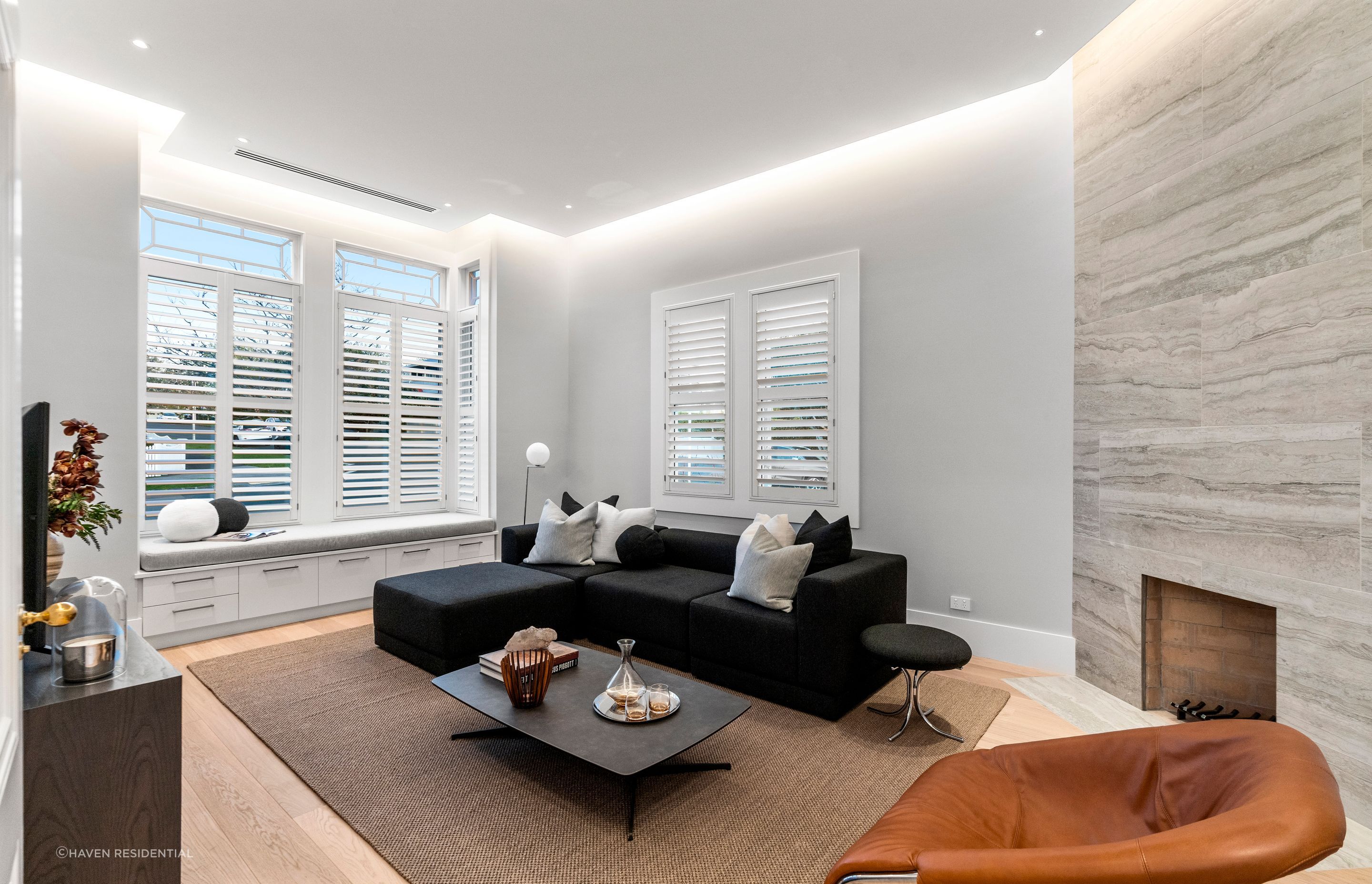 The living room features a floor-to-ceiling sandstone tile fireplace.