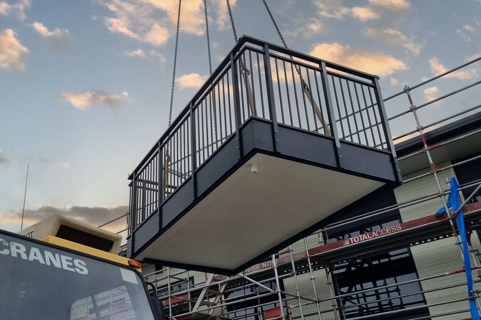 The prefabricated balcony being craned into place.