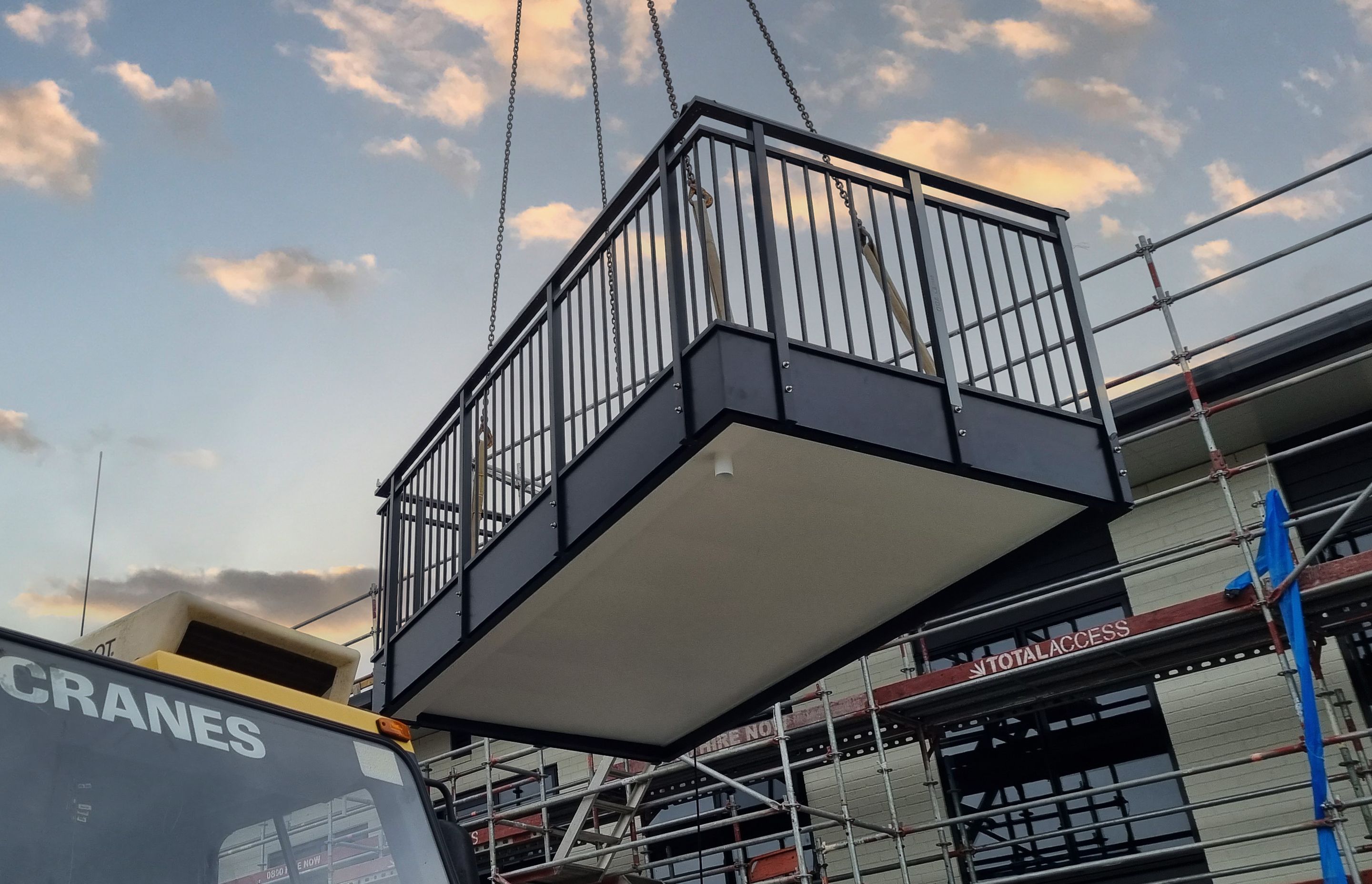 The prefabricated balcony being craned into place.