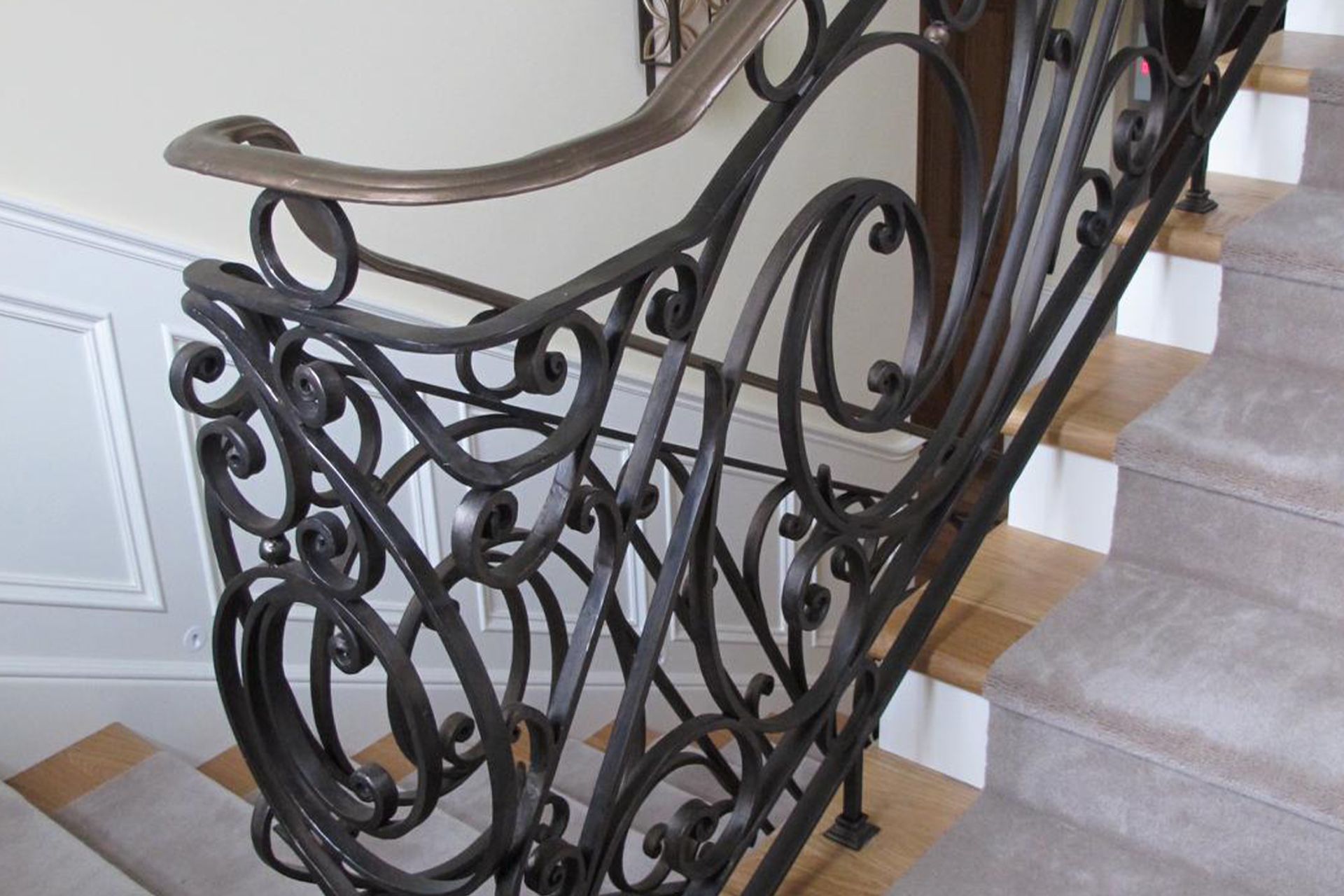 Features that take inspiration from organic shapes, like this custom balustrade from Wrought-Iron Specialists, can enhance the feelings of natural connection in the home.