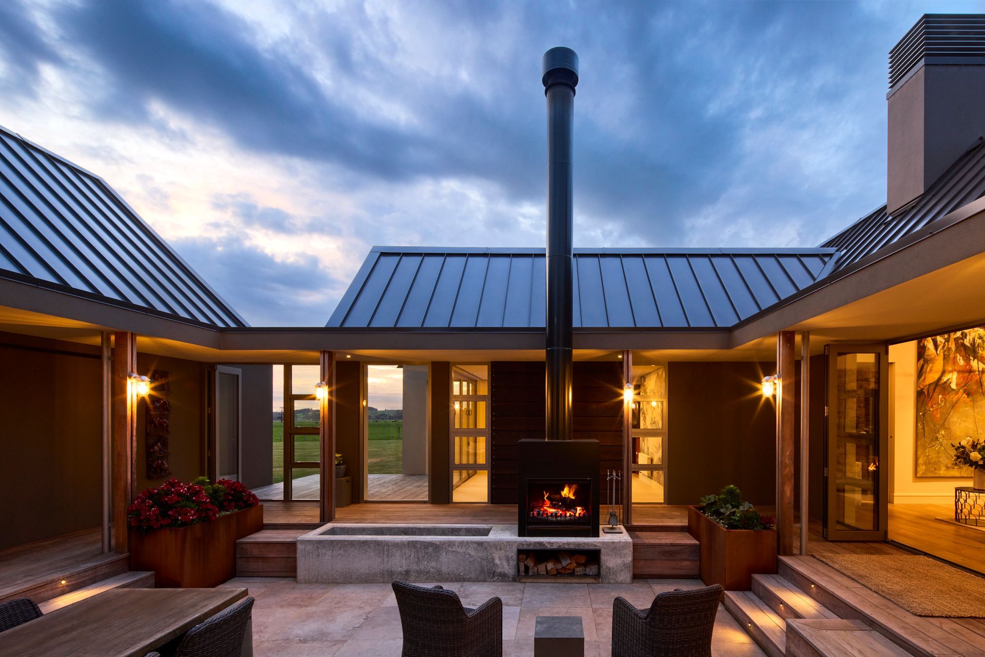 The internal courtyard at the centre of the home provides a sheltered outdoor gathering space, and has peaks through to the farmland beyond.