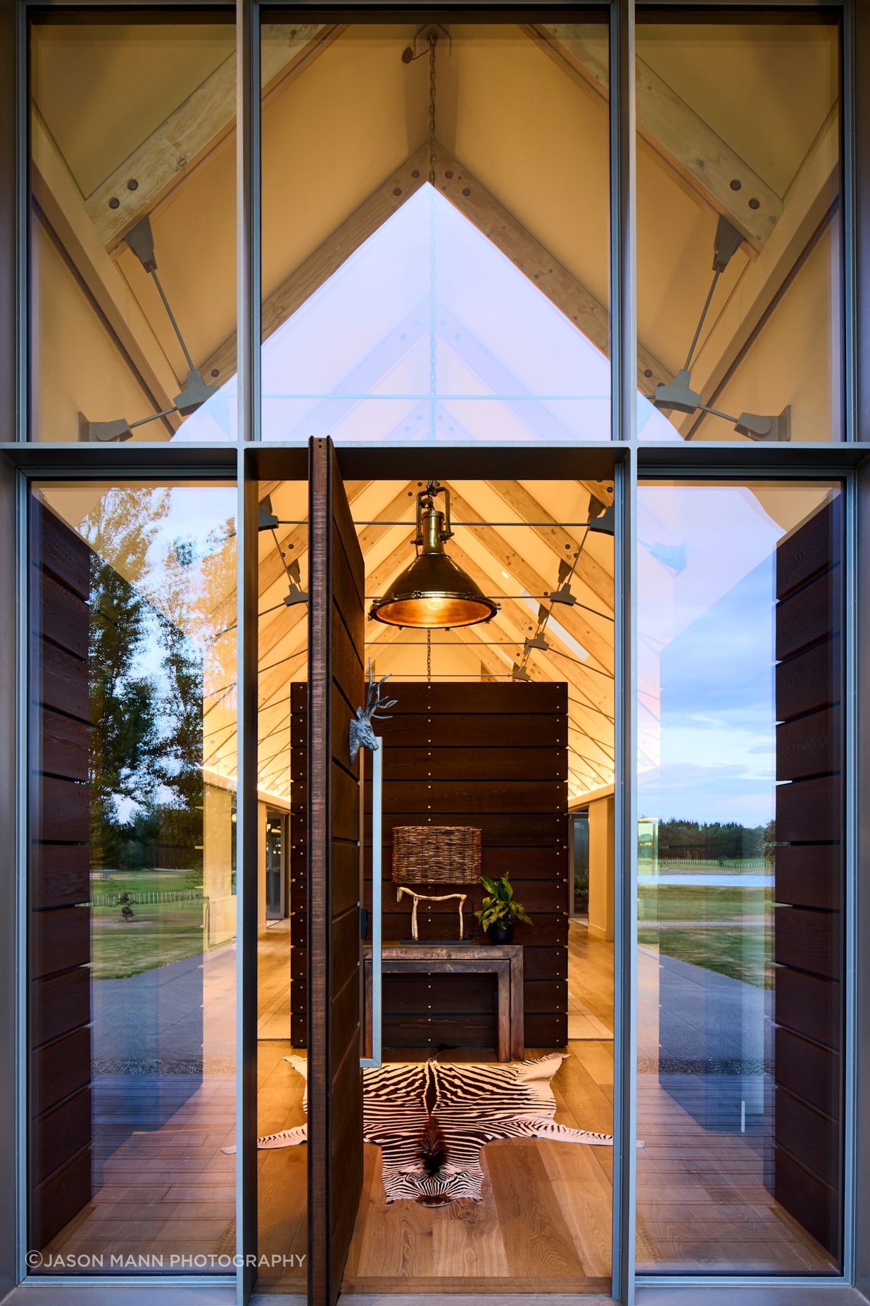 The entry features a clever pony wall, which helps reduce the volume of the space, and create a warm, yet dramatic entrance.