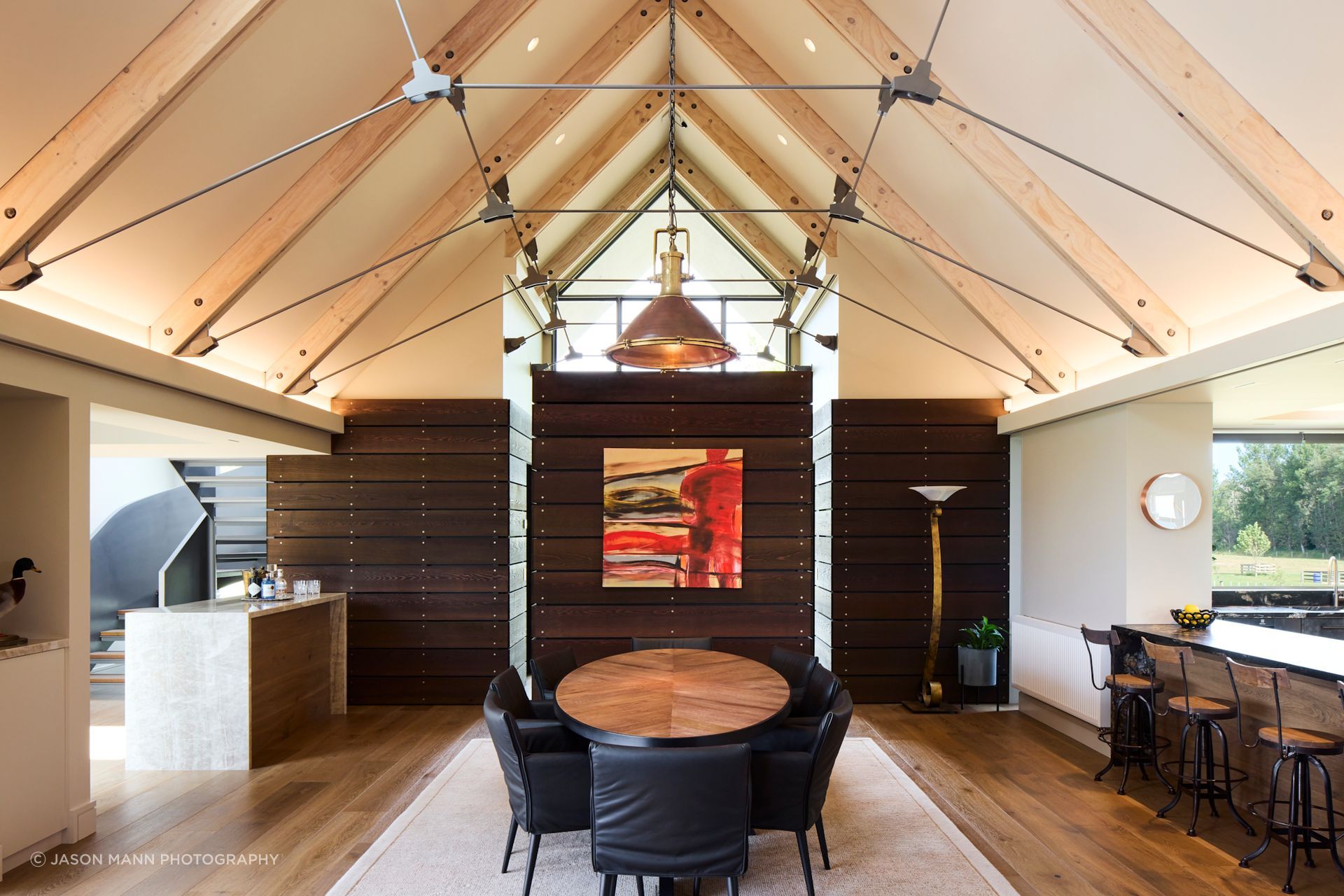 The volume of the living space is carefully broken up with different zones; the dining zone is at one end and is separated from the living space by a fireplace wall.  This enables full use of the footprint, without any 'dead' spaces, lost to corridors.