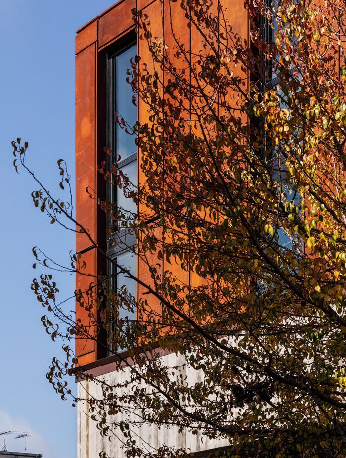 Its sturdy, stacked form and weathering steel facade echo the area's industrial roots.