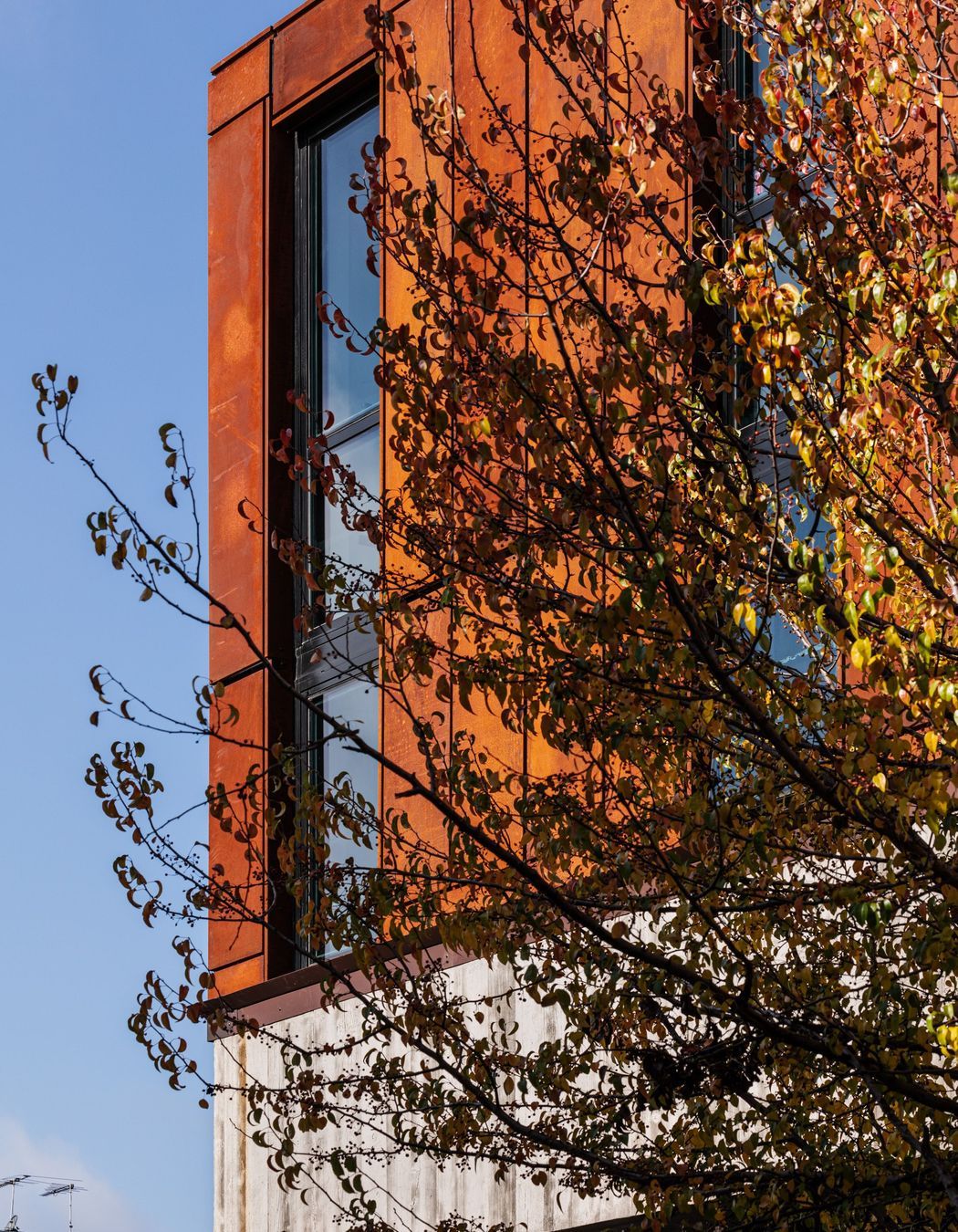 Its sturdy, stacked form and weathering steel facade echo the area's industrial roots.