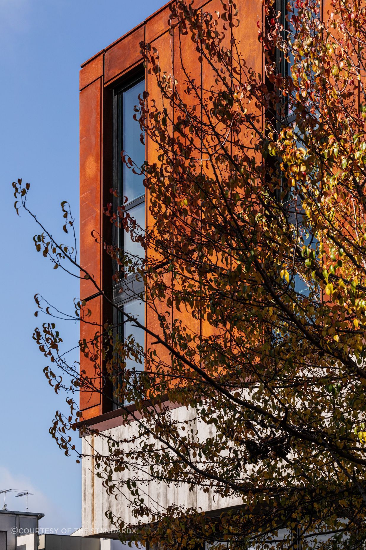 Its sturdy, stacked form and weathering steel facade echo the area's industrial roots.
