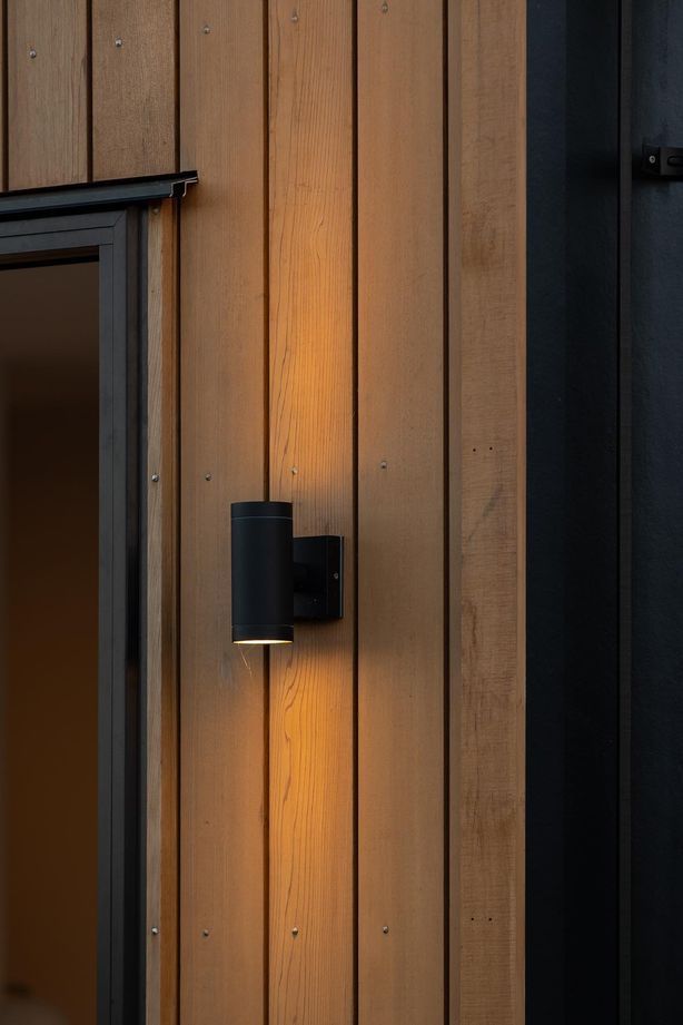 Up/Down Wall Lights are the perfect way to add an architectural lighting element to your exterior, showcased perfectly against the Cedarwood in this example.