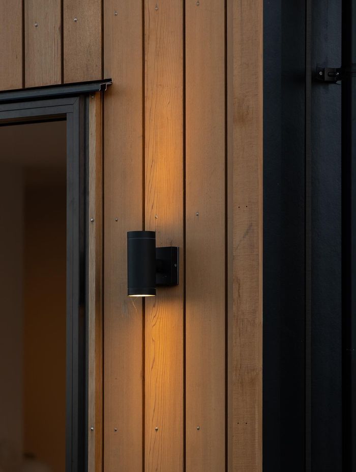 Up/Down Wall Lights are the perfect way to add an architectural lighting element to your exterior, showcased perfectly against the Cedarwood in this example.