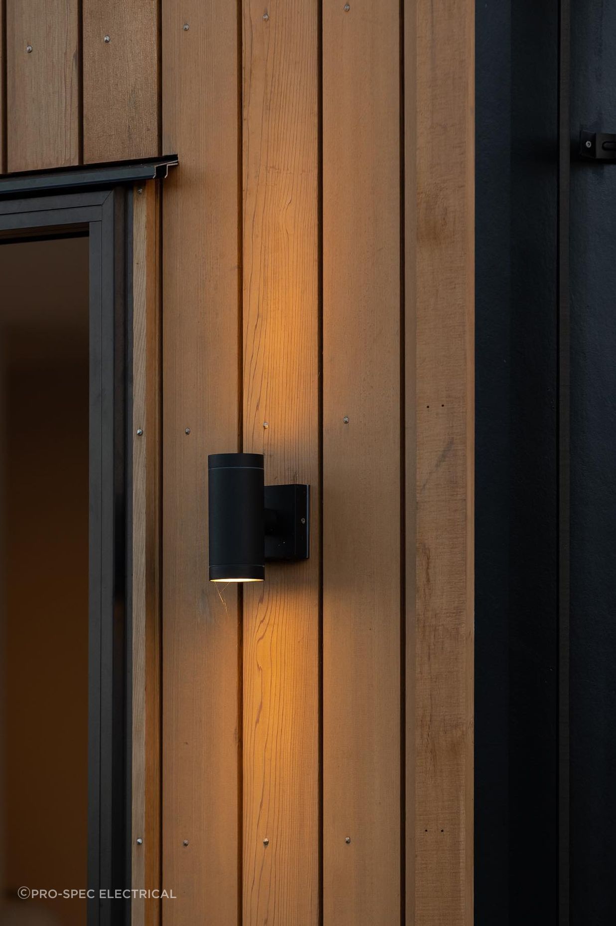 Up/Down Wall Lights are the perfect way to add an architectural lighting element to your exterior, showcased perfectly against the Cedarwood in this example.