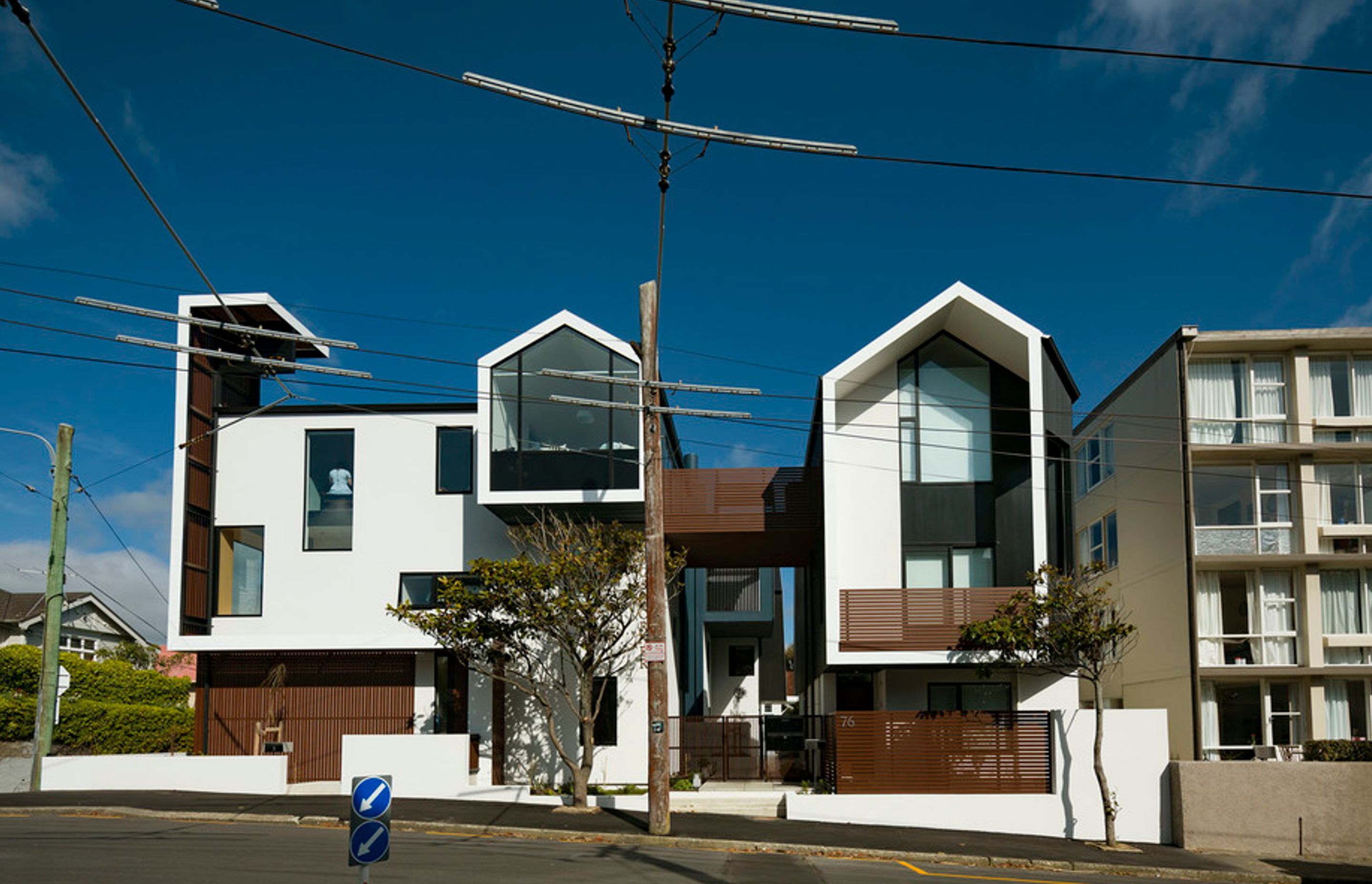 The multi-award-winning Zavos Corner Apartments in Wellington form a medium-density housing development on a small 564m² Mount Victoria corner site with eight apartments and a public clock tower defining the street corner. Photography by Jeff Brass.