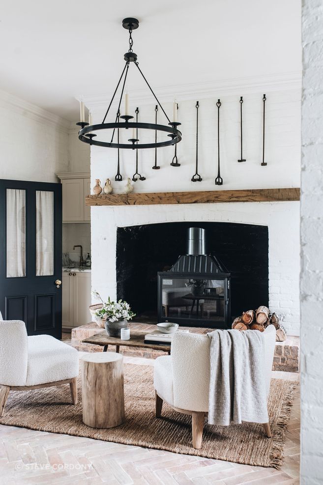 A luxurious farmhouse retreat in Orange, NSW, blending heritage charm with modern elegance, designed by Steve Cordony, featuring a characterful Seguin fireplace.