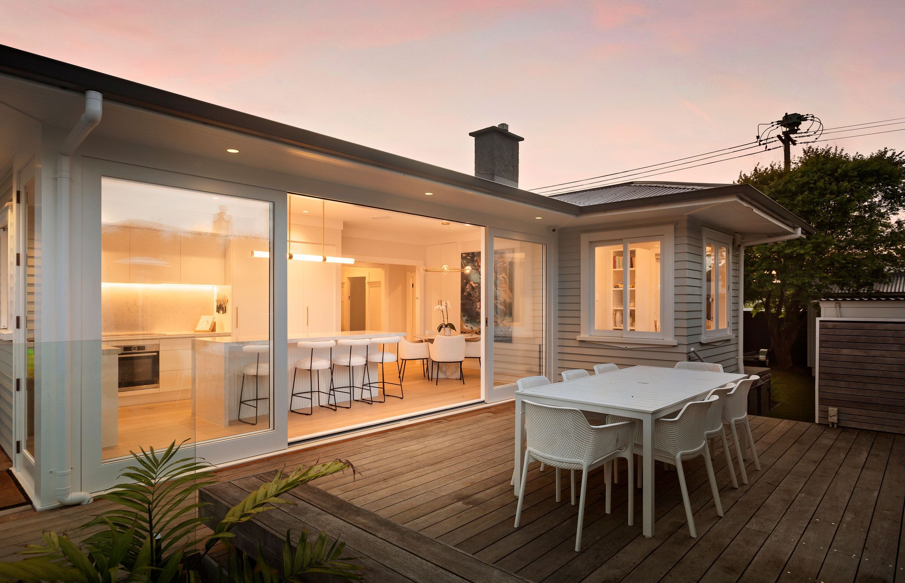 The renovation of this Point Chevalier bungalow opened the kitchen and dining area out onto a deck to create indoor-outdoor flow.