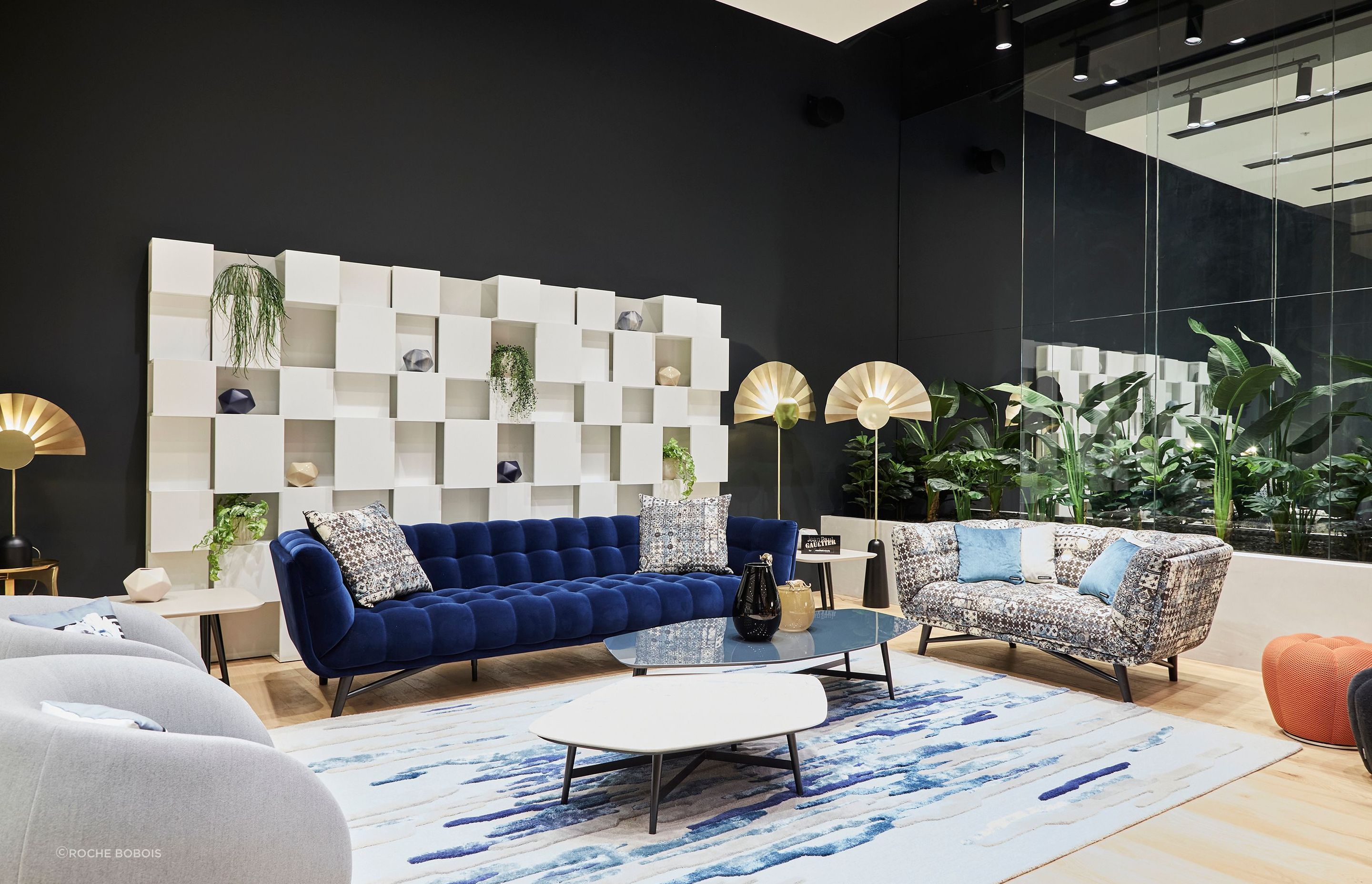The showroom houses diverse product categories, from furnishings and accessories to rugs, frames, and furniture.
