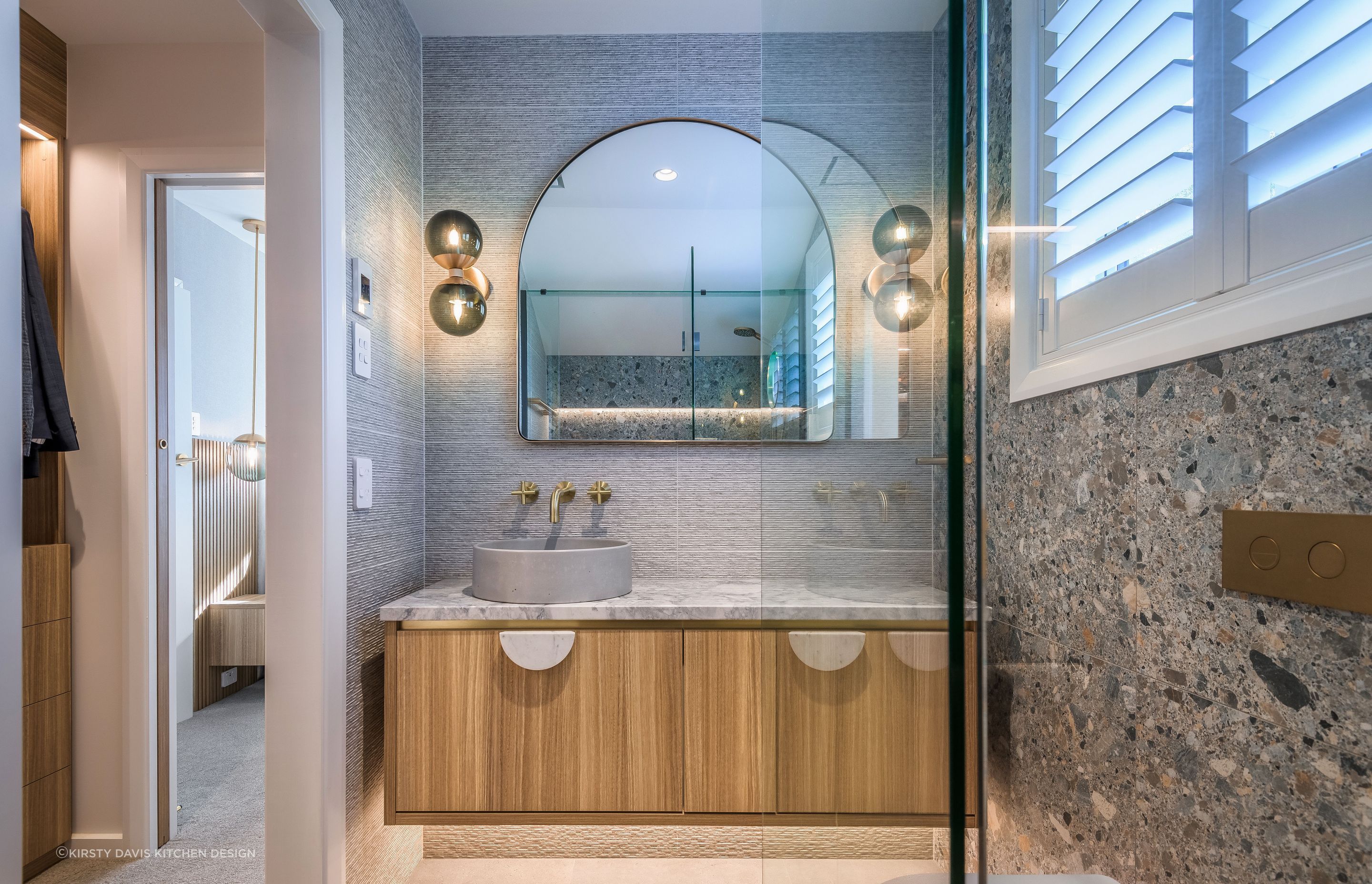Larger bathroom mirrors like this beautiful arch model in this Wairakei Road renovation look great and work well with wall lights