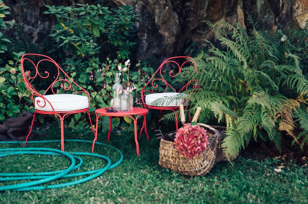 The 1900 Cabriolet Armchair by Fermob exudes an undeniable sense of French charm.