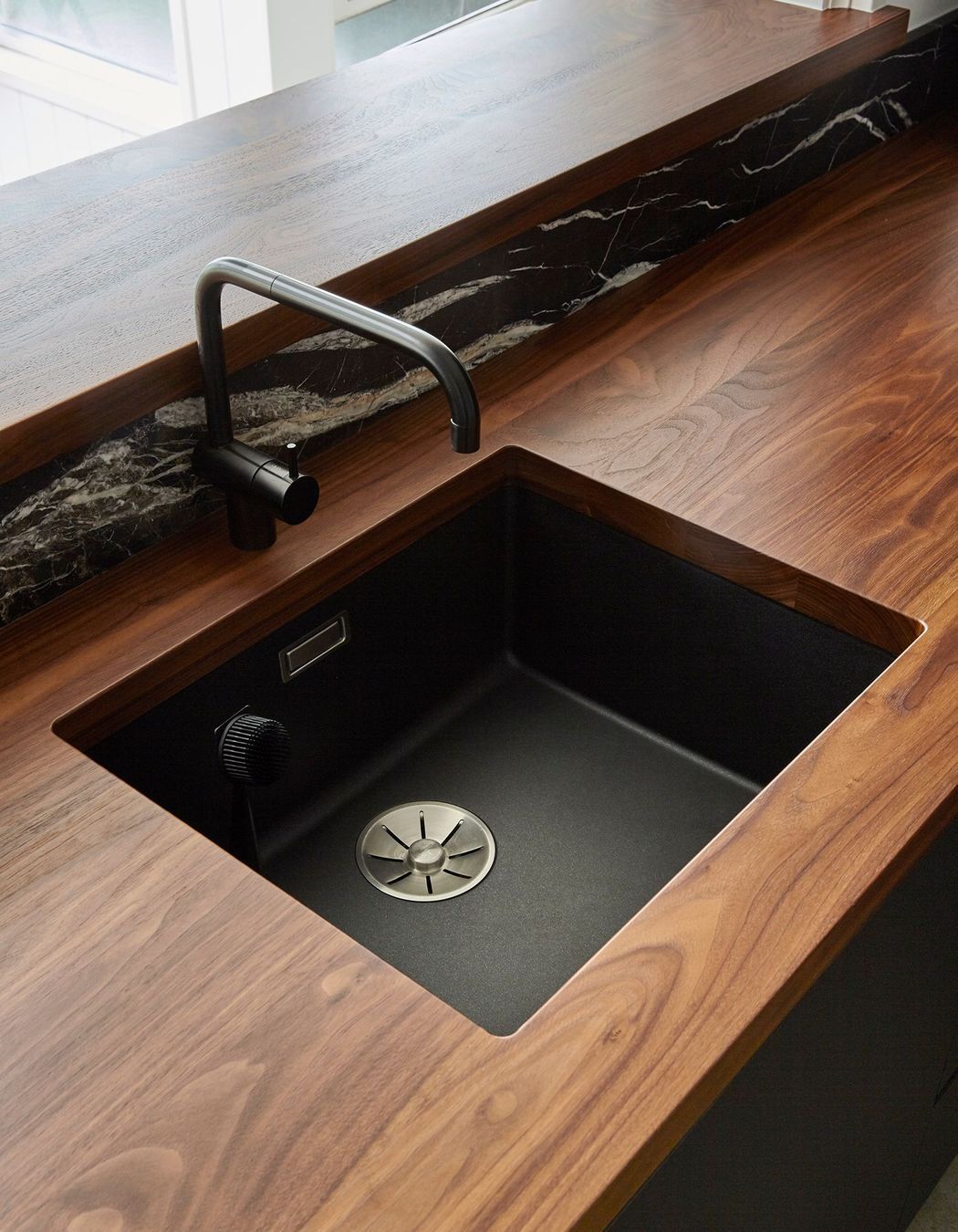 Solid walnut-timber benchtops add luxury and warmth to the heart of the home.