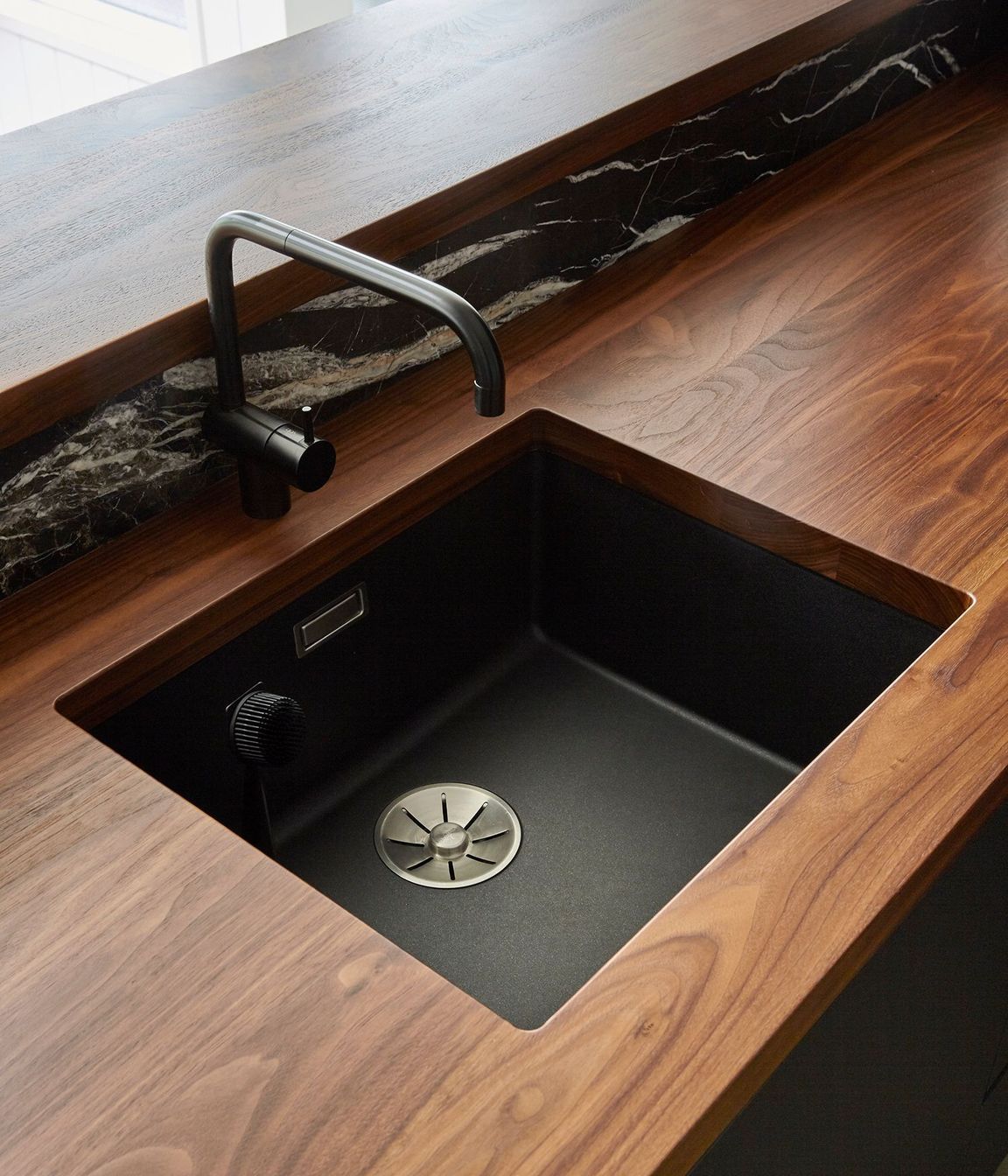 Solid walnut-timber benchtops add luxury and warmth to the heart of the home.