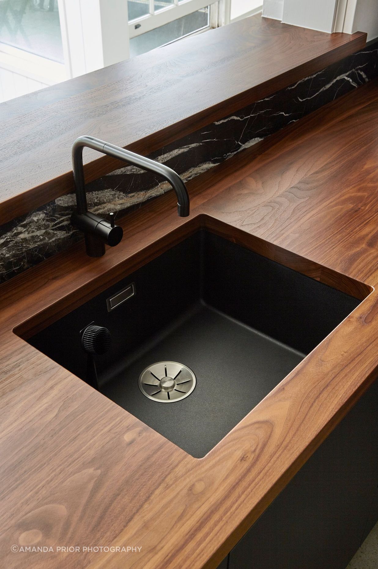 Solid walnut-timber benchtops add luxury and warmth to the heart of the home.
