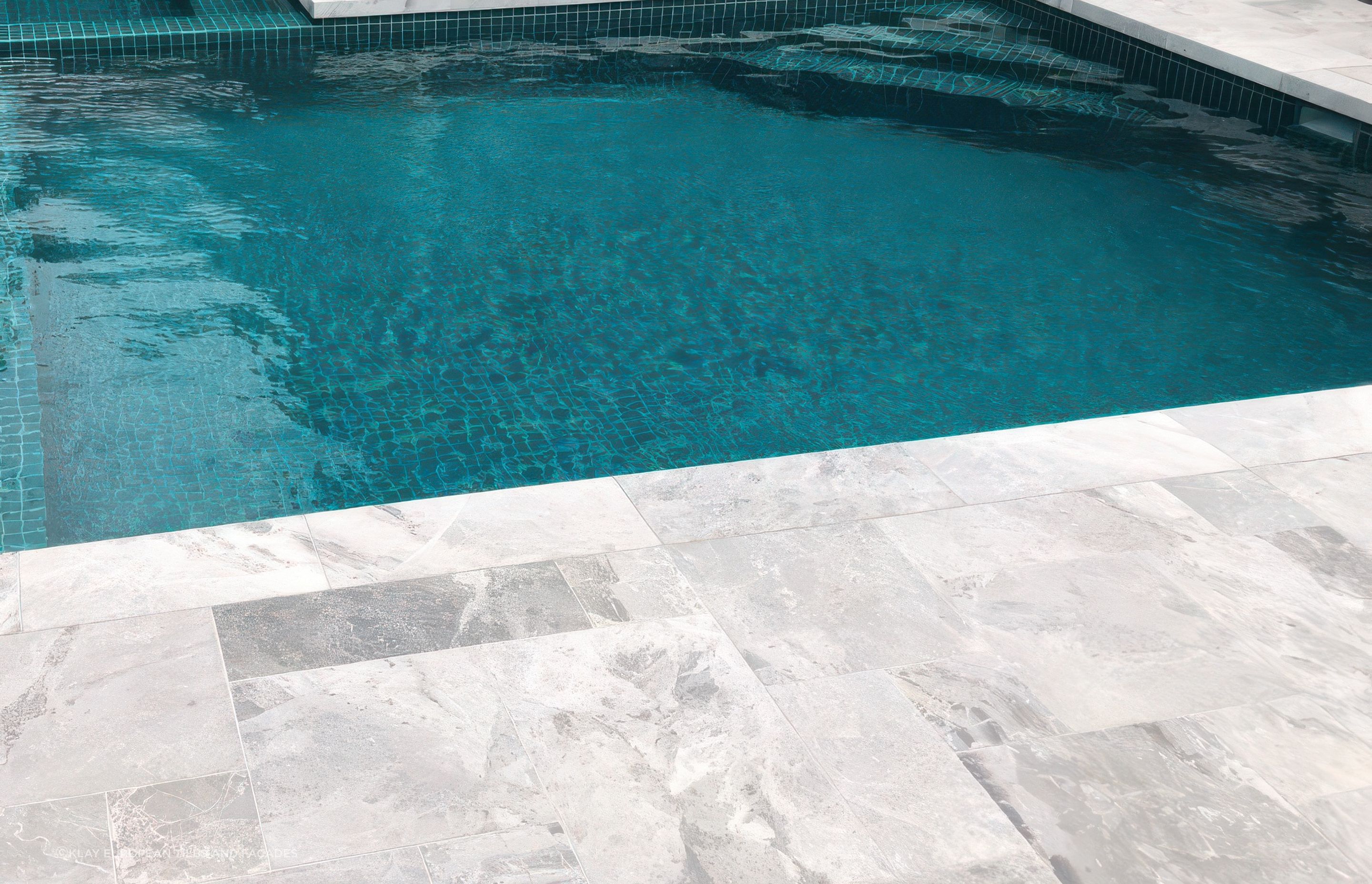 Marble in French Pattern paving with Jade Green 48×48 Pool Tile. Pool by Hamill Pools