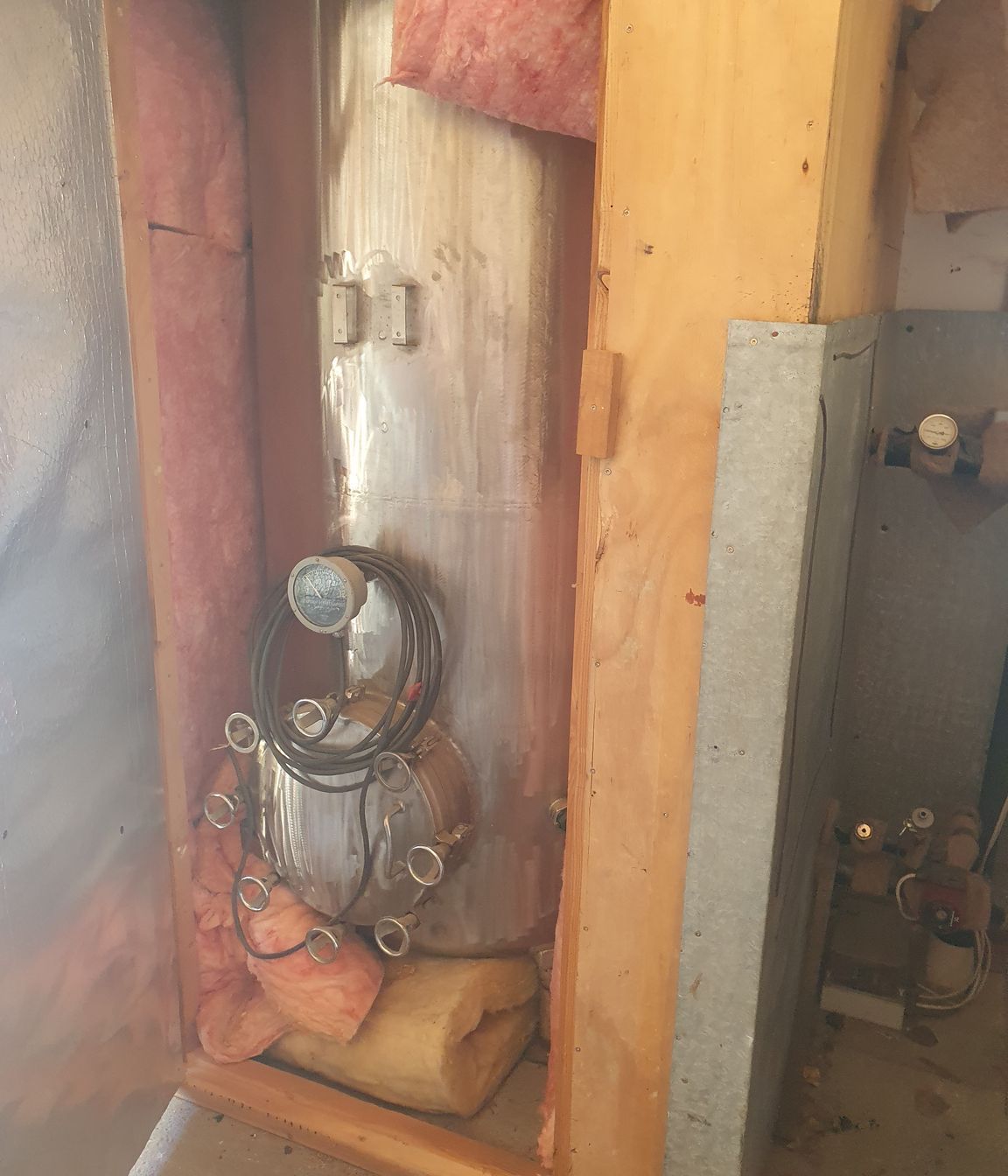 The original hot water cylinder connected to the client's multi-fuel burner.