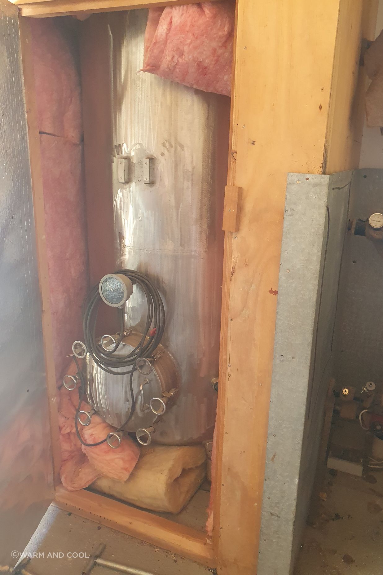 The original hot water cylinder connected to the client's multi-fuel burner.