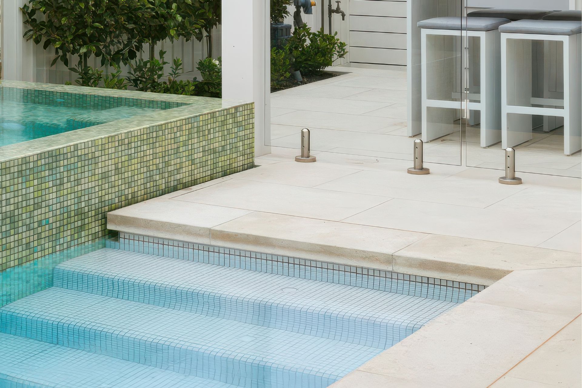 Limestone with Fresh Snow White 25×25 Pool Tile. Pool designed by Mint Landscape Design