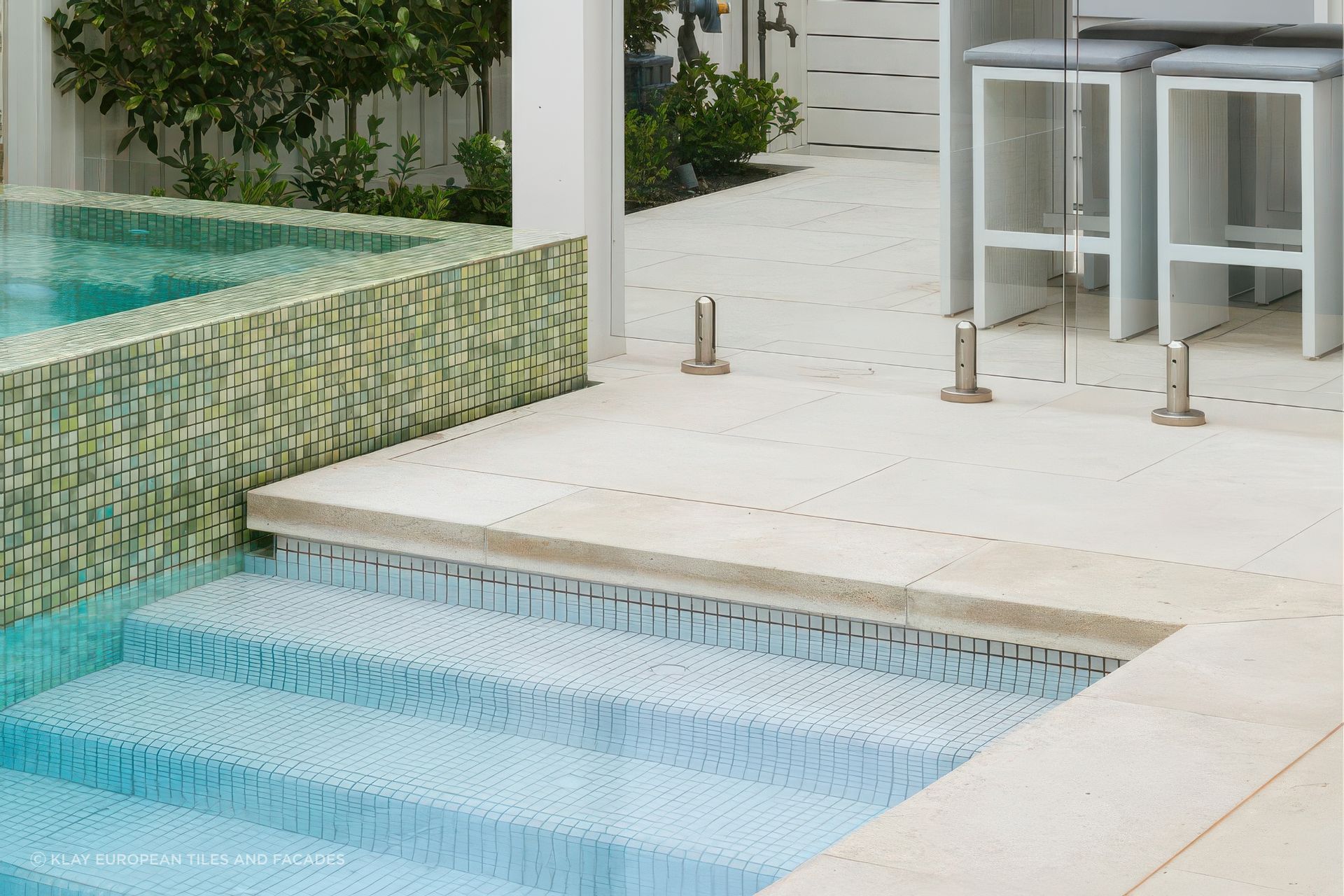 Limestone with Fresh Snow White 25×25 Pool Tile. Pool designed by Mint Landscape Design