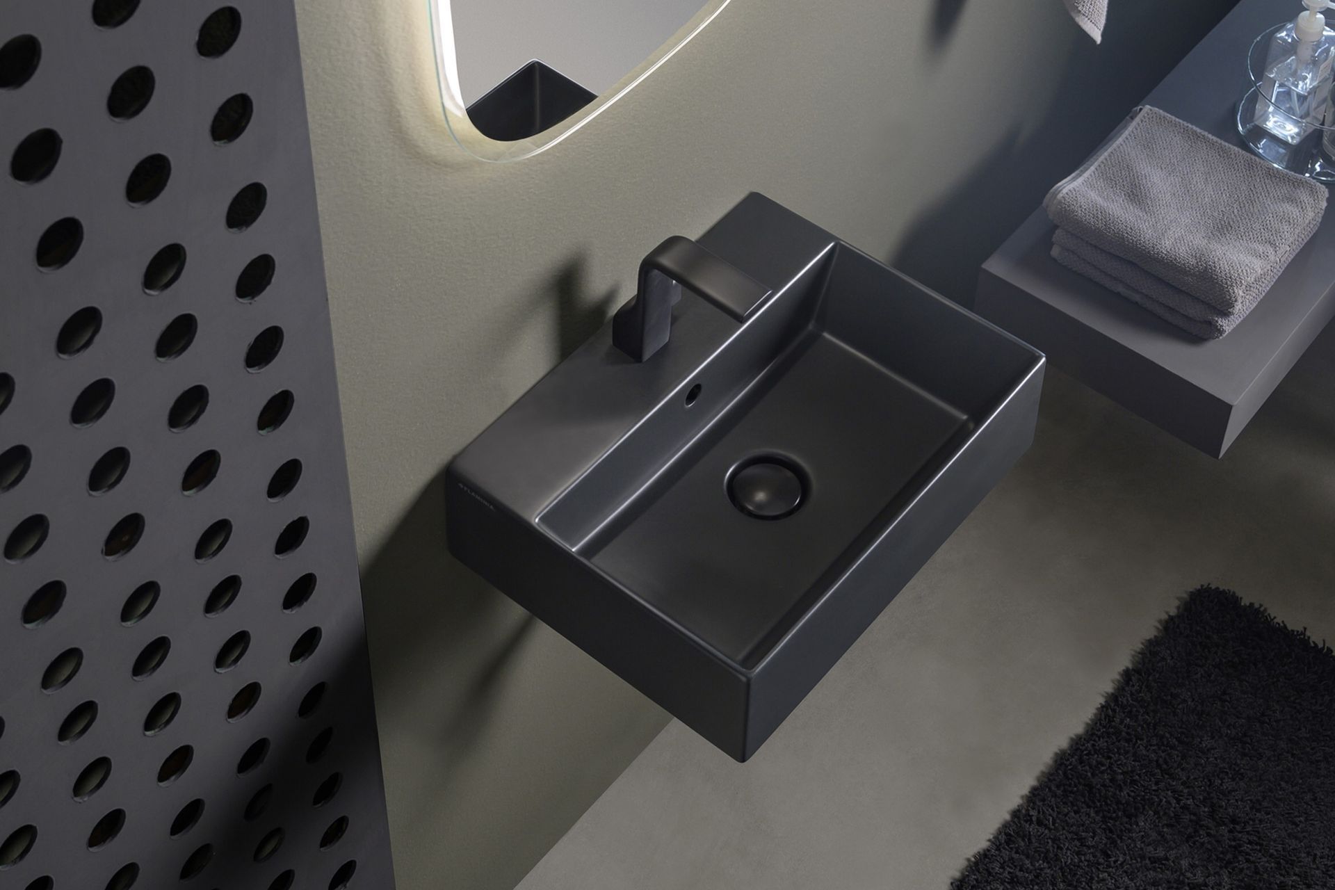 The App light vessel basin, seen here in a carbone finish, works in both residential and commercial settings.